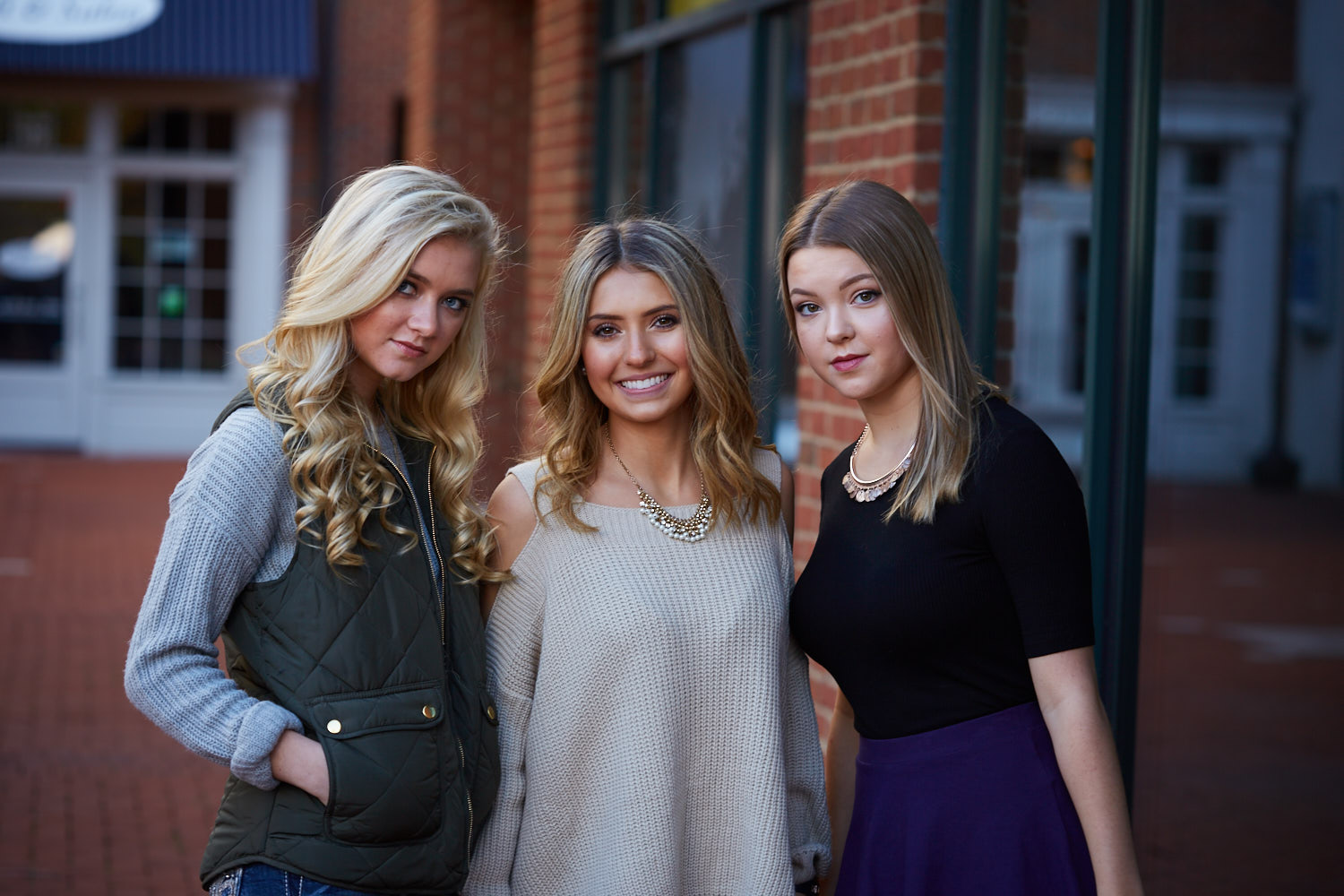 Three Senior girls pose in courtyard