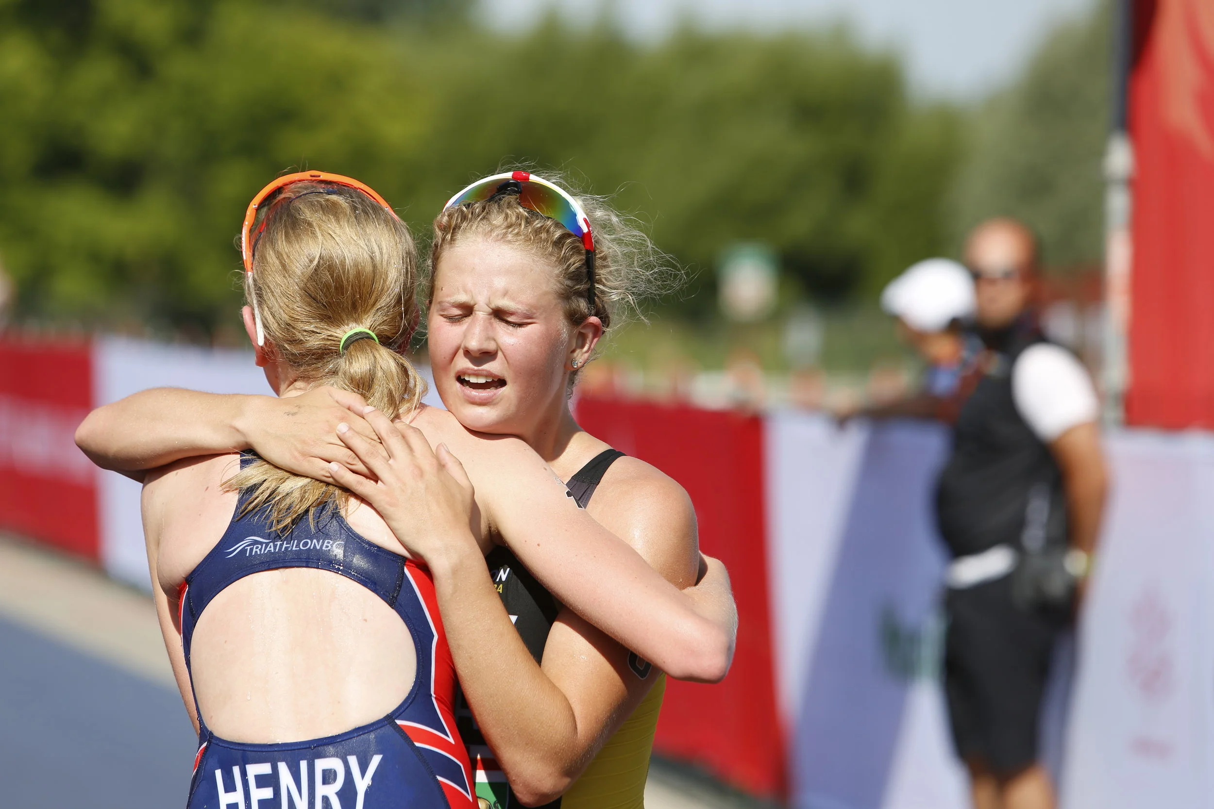  JUSTIN SAMANSKI-LANGILLE / WINNIPEG FREE PRESS Manitoba's Kyla Roy embraces B.C's Hannah Henry at the finish line during Monday's women's triathlon at Birds Hill Park. B.C. athlete Desirae Ridenour finished first, teammate Henry finished second and 