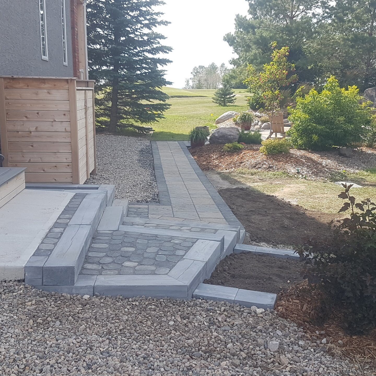 Added steps and a walkway to allow easier access to existing paving stone patio. 
#barkmanconcrete #bridgewood #techoblocpavers #antika