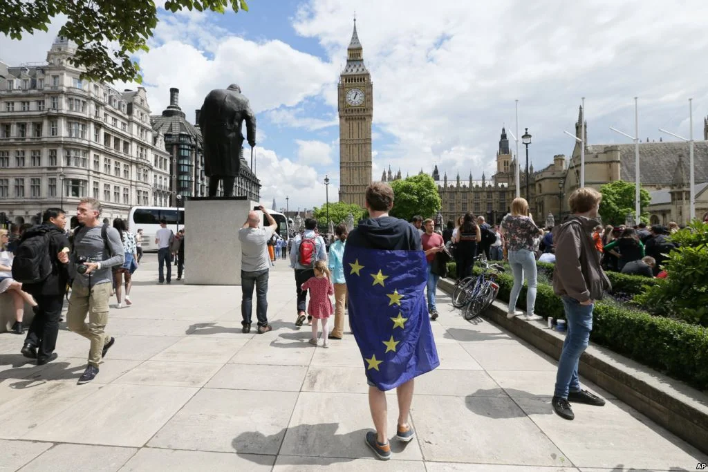 A demonstrator wrapped in the EU flag takes part in a protest opposing Britain’s exit from the European Union in Parliament Square in London following the EU referendum result. TIM IRELAND The Associated Press