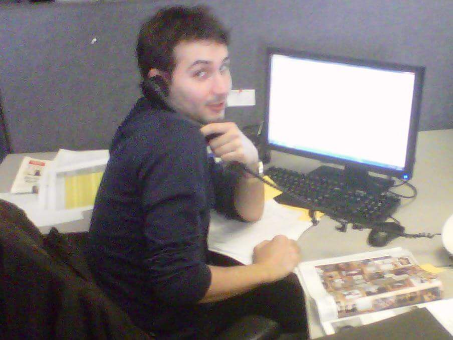 At his desk