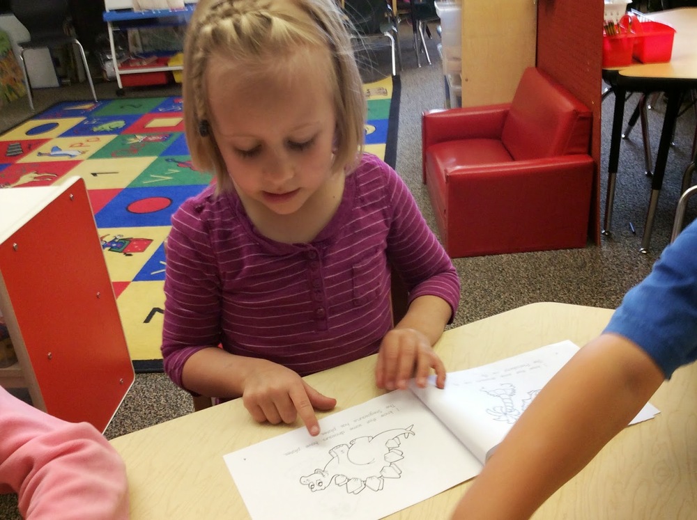 At the guided reading table, students are able to strengthen reading skills while reading theme-based readers.