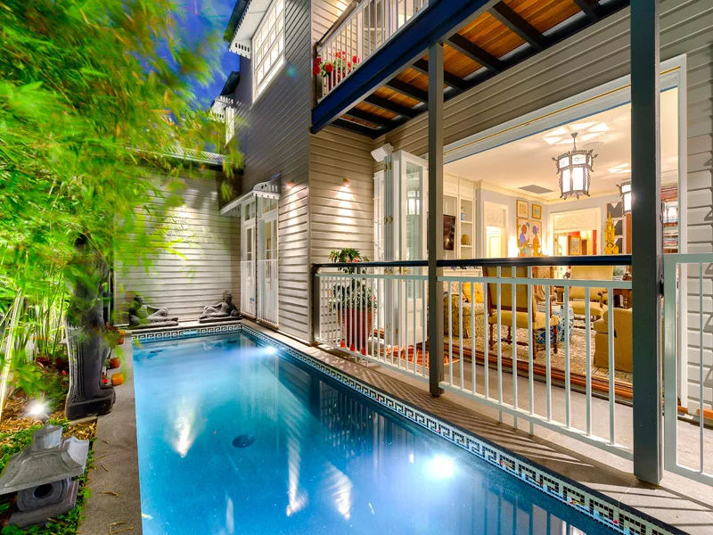 In Brisbane in Summer Months one would regard a swimming pool a necessity, rather than a luxury. On inner city blocks of land, one has to imagine sometimes how a pool can fit the building site, but one should also not be limited by something that may appear difficult. The above image was one such example of a difficult block of land, but with extensive renovations to the original house, it allowed easier access to the rear of the home for the pool to be constructed. The result is a pool that fits perfectly into the confined area, without overwhelming the house. The bifold doors of the downstairs Sitting Room, retract to allow a large open expanse overlooking the pool area, and Balinese inspired gardens. Allowing the interiors to be an extension to the outside area , which also creates the feeling of more space, internally and externally. A very successful integration, of using land, architecture and interiors to create the perfect inner city home.