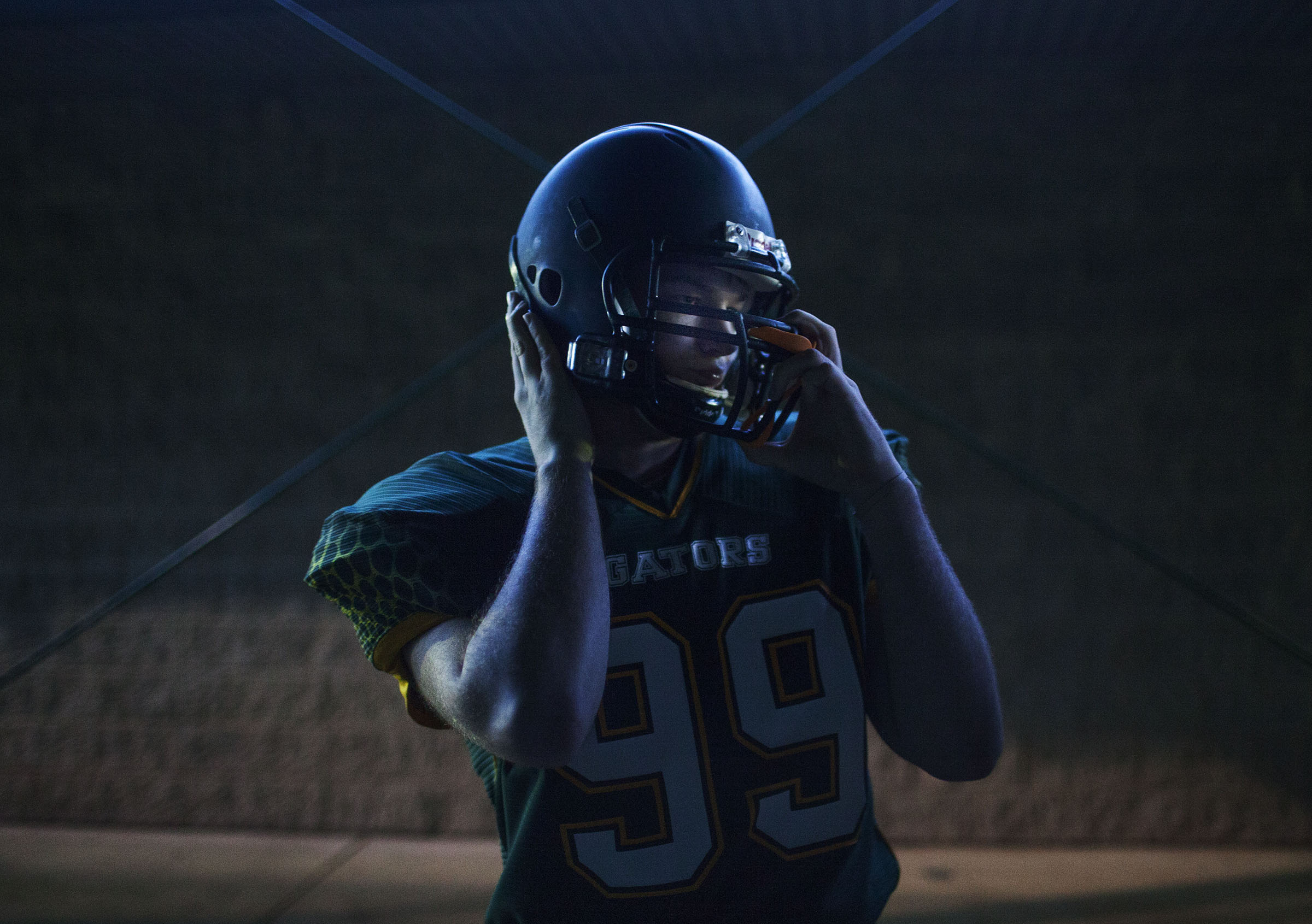 Greenwood senior Blake Kirby puts on his helmet before their game against Logan County on Friday, Sept. 18, 2015, at Greenwood. Kirby has an unknown form of Ataxia, but both teams agreed to let him run the ball in for a 2-point conversion during the game. 