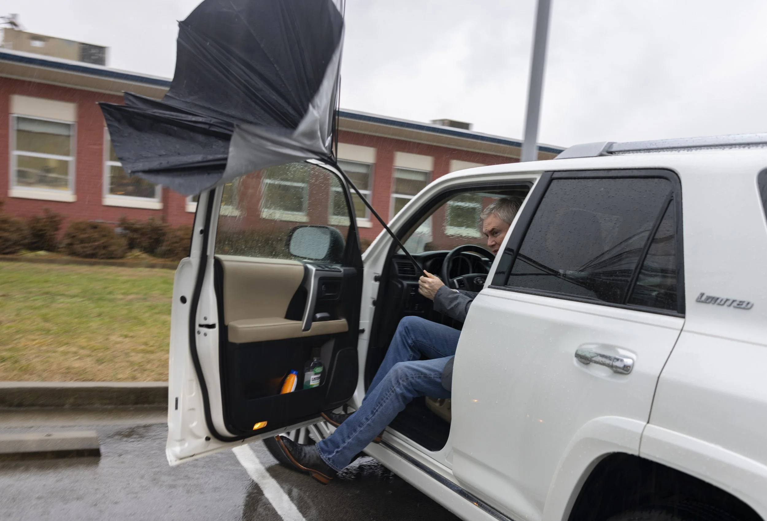  Representative James R. Comer, Republican of Kentucky, struggles with his umbrella as a gust of wind flips it inside-out as he get into his car on Thursday, Feb. 16, 2023, in Edmonton, Ky. (Austin Anthony for the New York Times) 