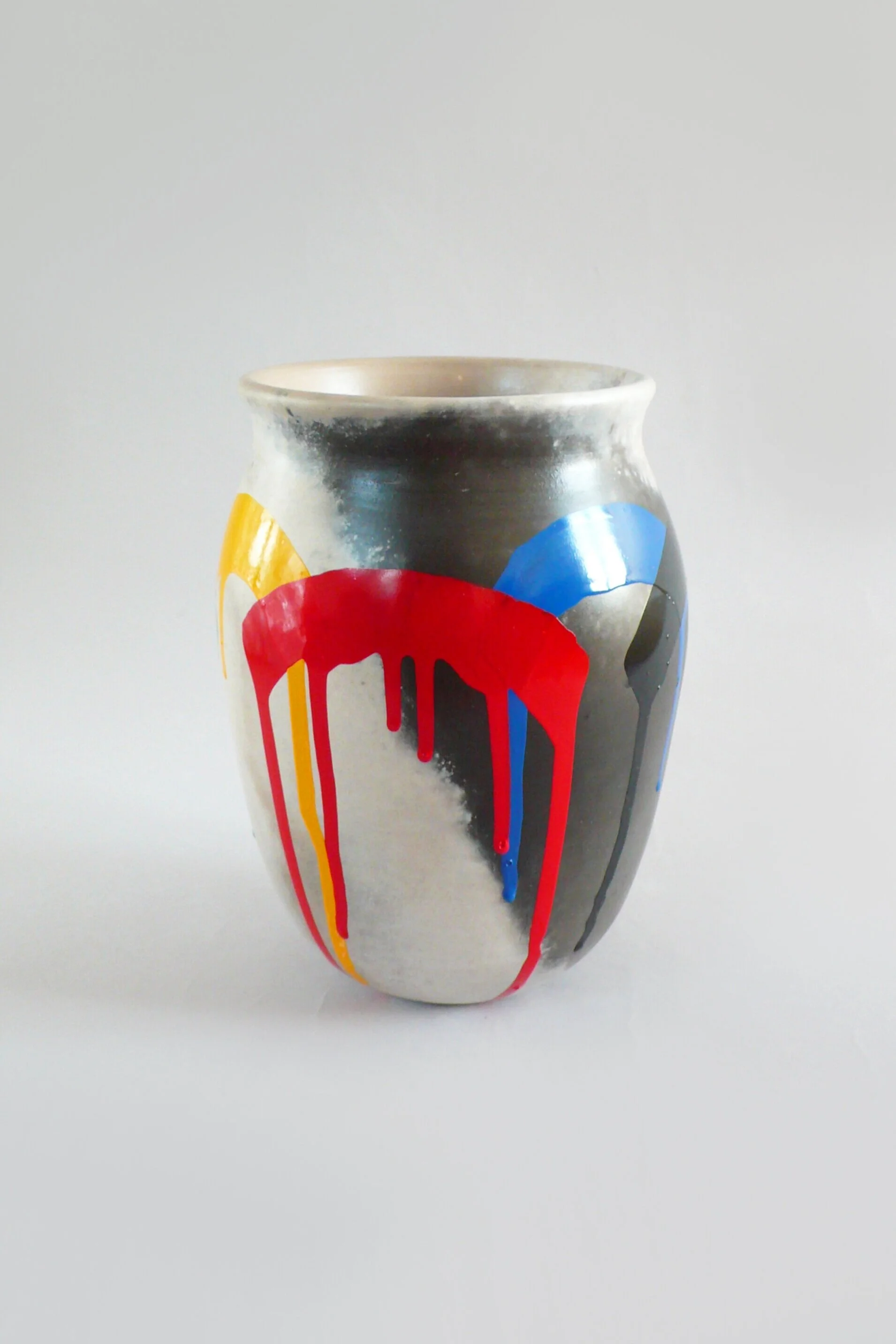 Smoke-fired vase with painted enamel decoration