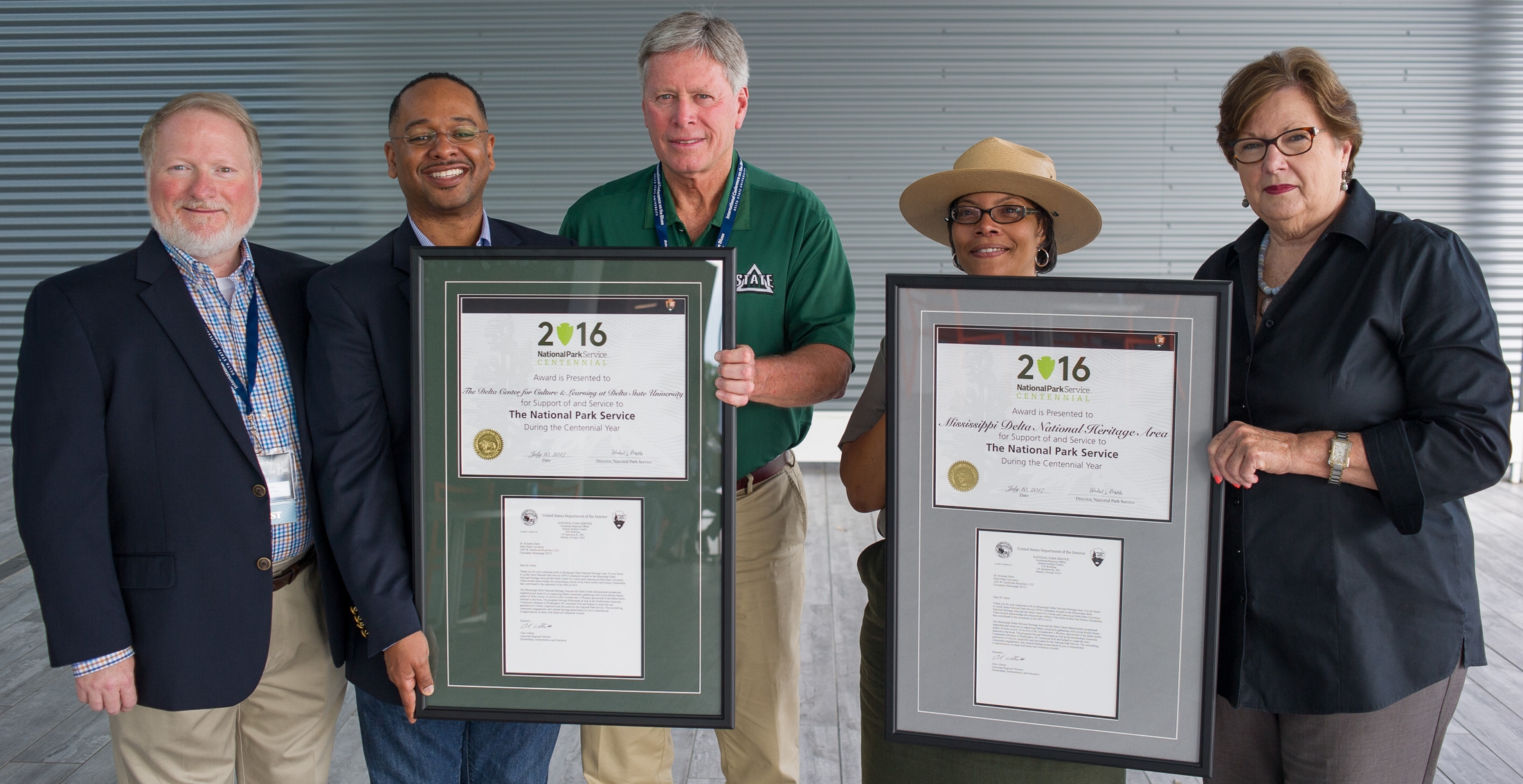 This week, the National Park Service (NPS) presented the agency’s prestigious Director’s Centennial Award to Mississippi Delta National Heritage Area (MDNHA) and Delta Center for Culture and Learning at Delta State University for their work establishing the Delta Jewels Oral History Partnership in Mississippi. The partners collaborated with Pulitzer Prize-winning photojournalist and author Alysia Burton Steele in a yearlong initiative through Spring 2016 to host community engagement activities featuring oral histories and stories of African-American church mothers in the Mississippi Delta. Pictured (l to r): Delta State University Provost and Vice President of Academic Affairs Dr. Charles McAdams, Delta Center for Culture and Learning and Mississippi Delta National Heritage Area executive Dr. Rolando Herts, Delta State University President William N. LaForge, Vicksburg National Military Park Acting Superintendent Fonce' Bates, and Mississippi Delta National Heritage Area Board Chair Dr. Myrtis Tabb. Credit: Will Jacks.