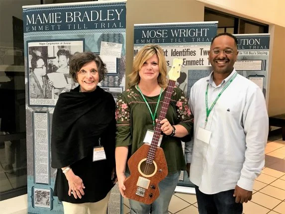 NEH Most Southern Institute participant Toni Dringman (center) from Kansas donating a guitar made by her husband to The Delta Center.