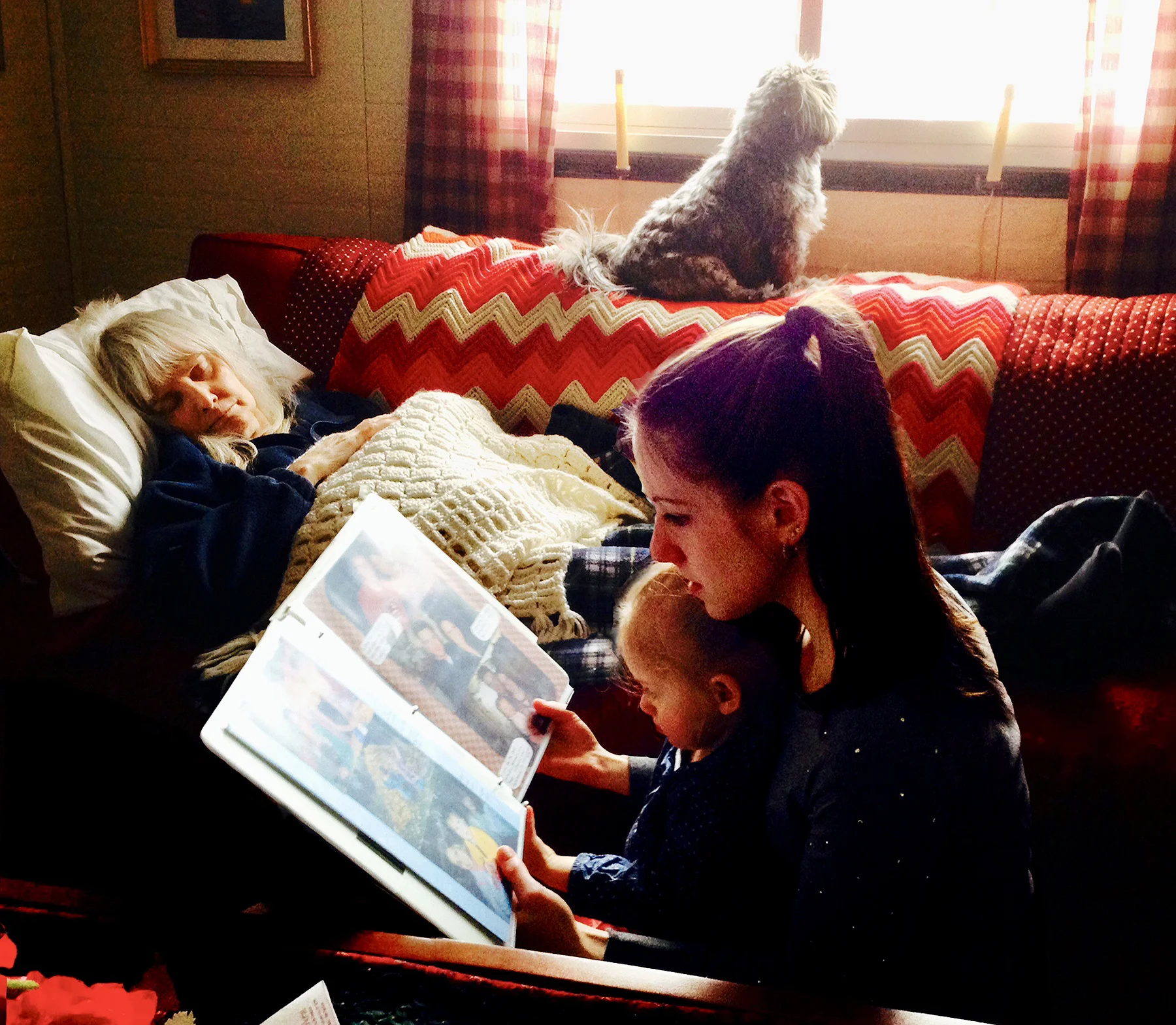My daughter Mackenzie, and granddaughter Mia looking at scrapbooks by my mother’s bedside.