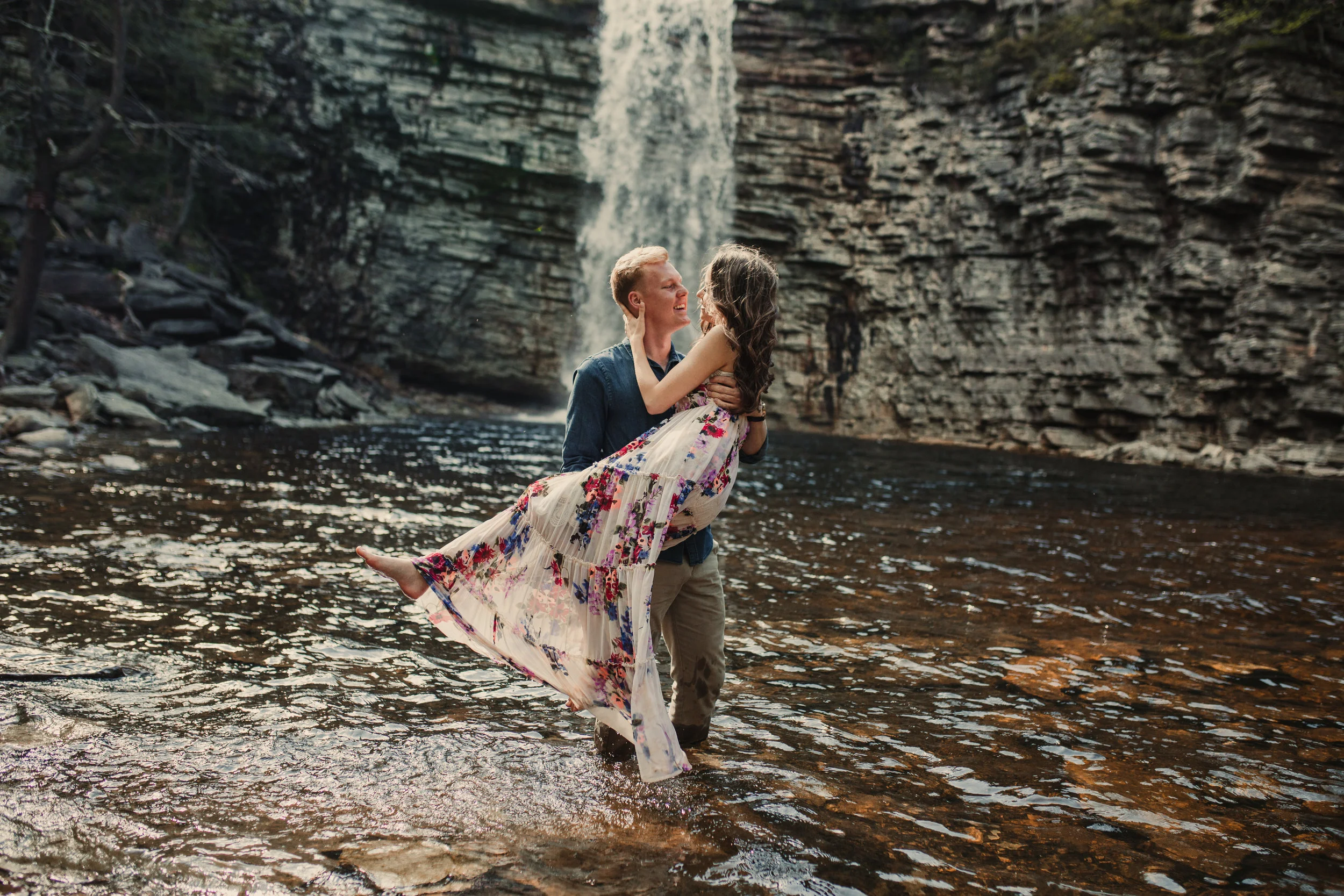 Couple in water at the bottom of Awosting Falls in Minnewaska State Park - Gardiner, New York