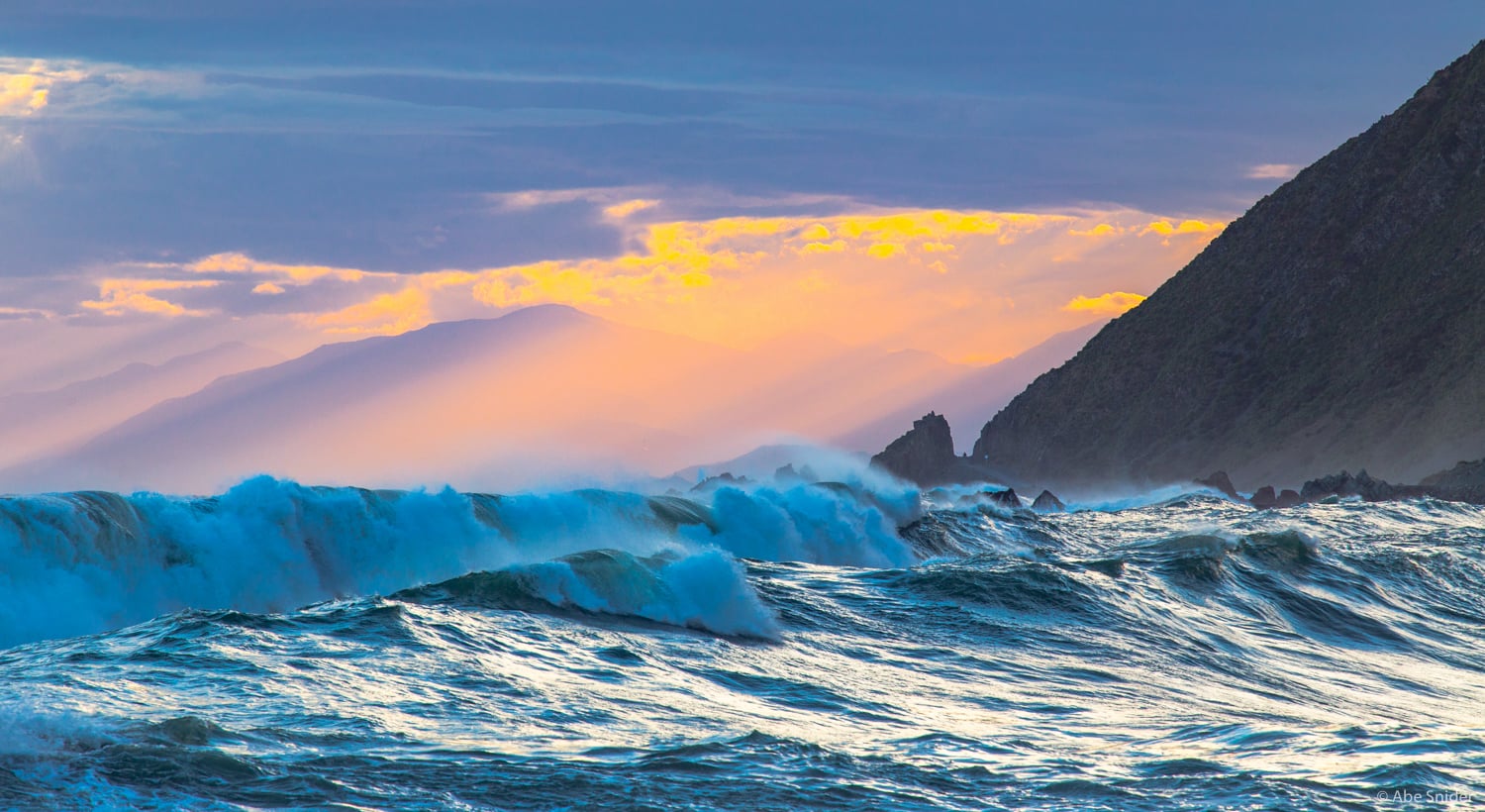 The hills of the south island can be seen from Owhiro Bay, south of Wellington at the bottom of the North Island. 