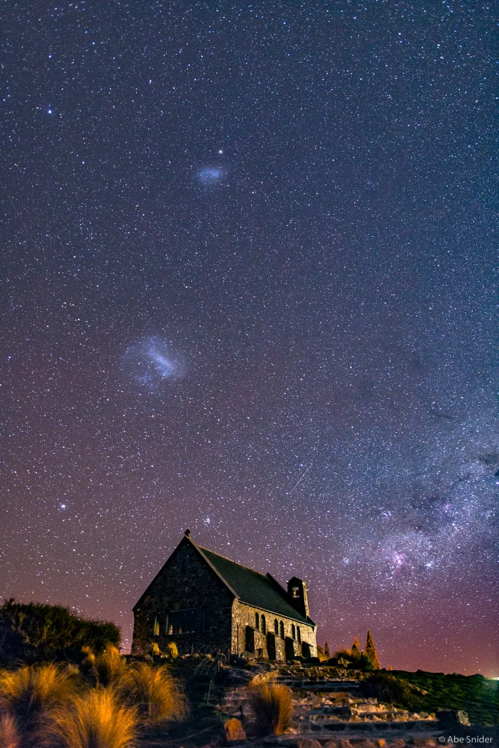A wider shot of the LMC & SMC above the Church of the Good Shepard in Lake Tekapo, New Zealand. The Carina Nebula is off to the lower right. 