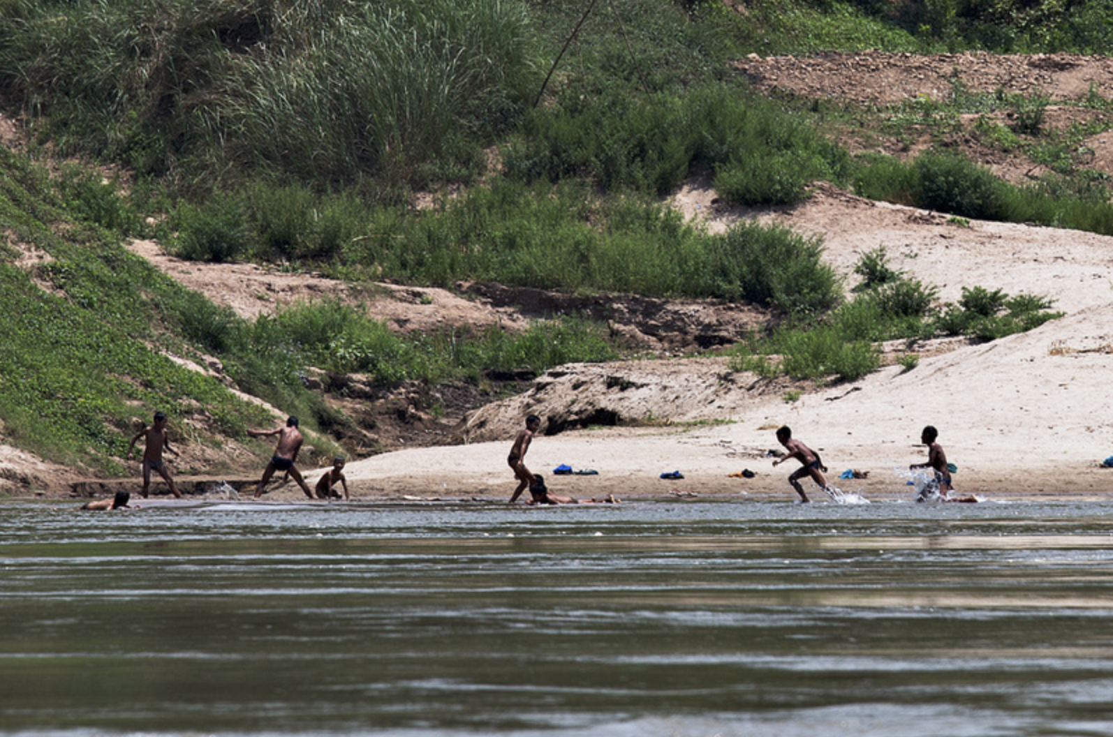 Hilltribe children play in the river.