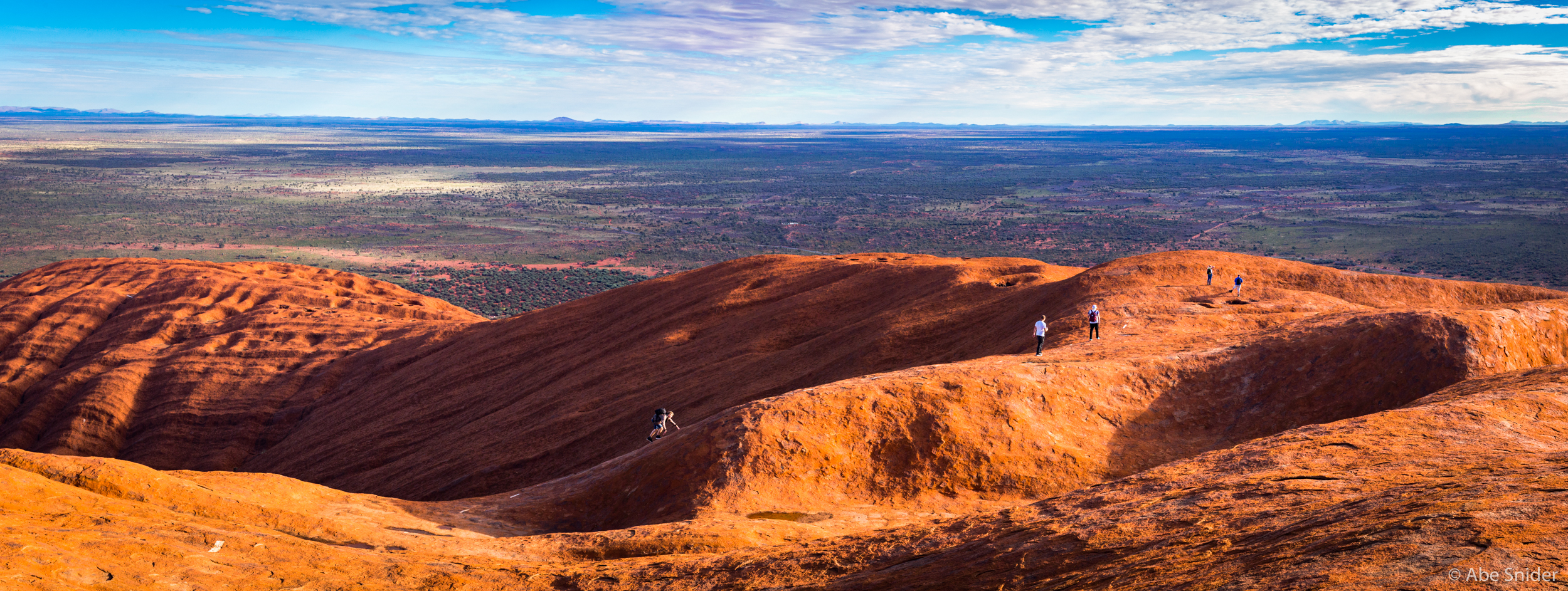 Hikers make the climb back to the false summit to make their descent about an hour before sunset. 