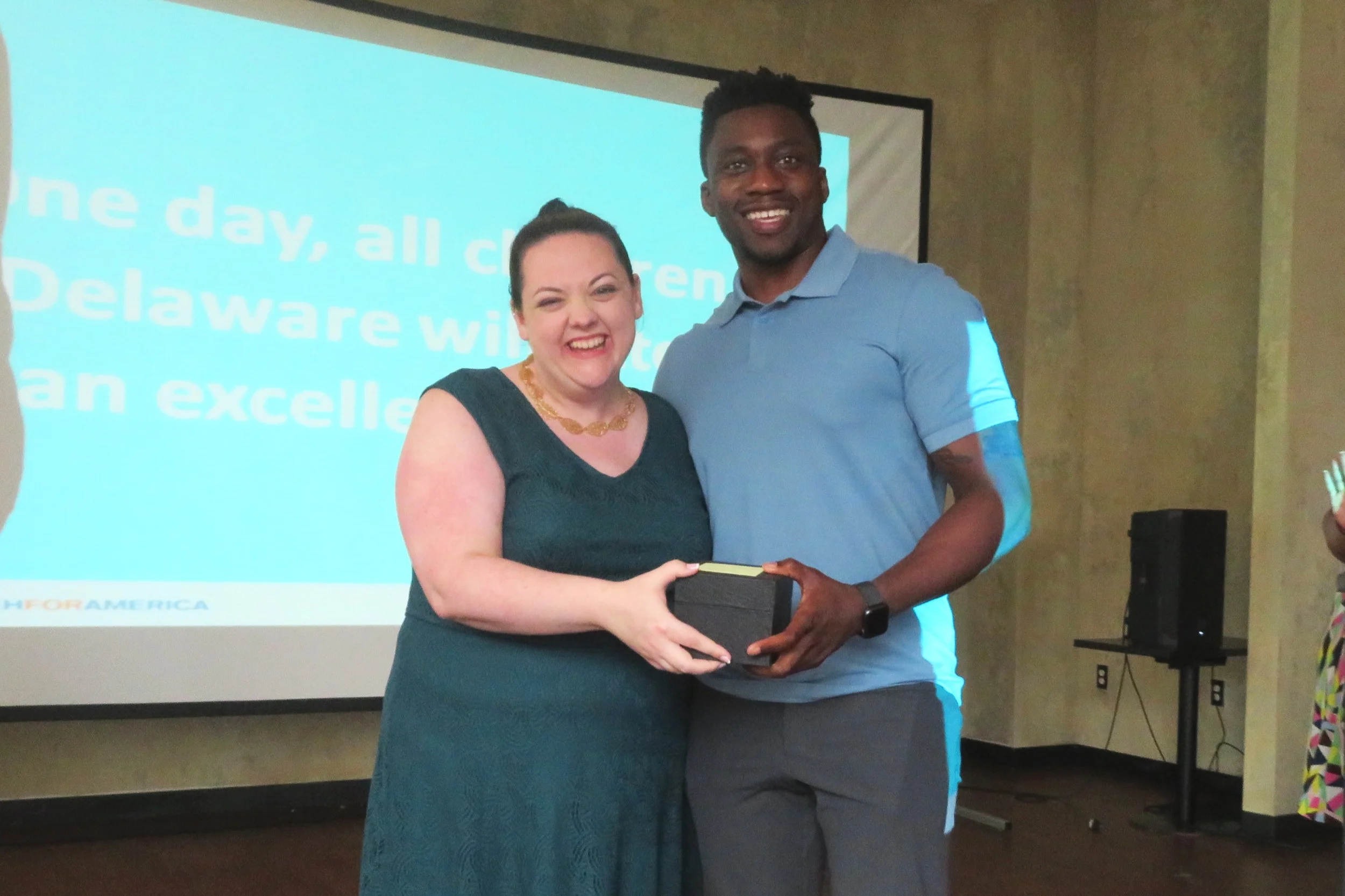 Dr. Alleyne accepts the award from Erin Fitzgerald, Sr. Managing Director, Continuum, TFA-Delaware