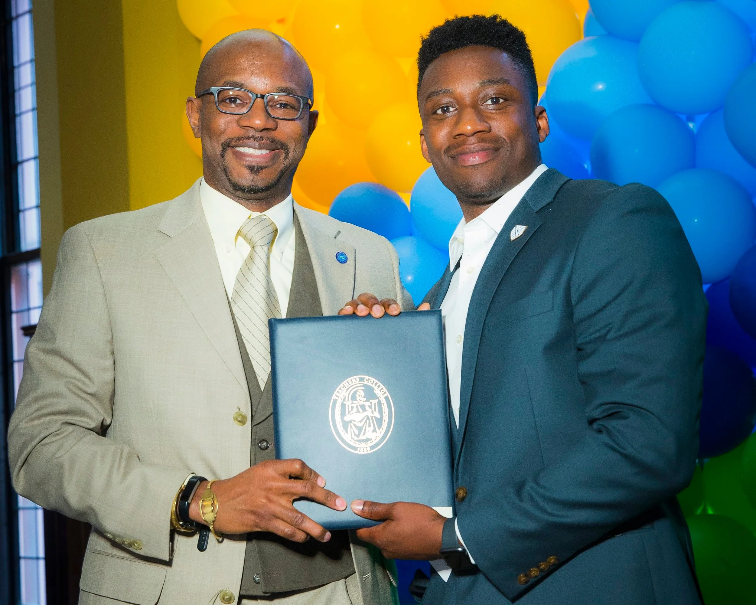 Dr. Alleyne accepts the award from Erin Fitzgerald, Sr. Managing Director, Continuum, TFA-Delaware