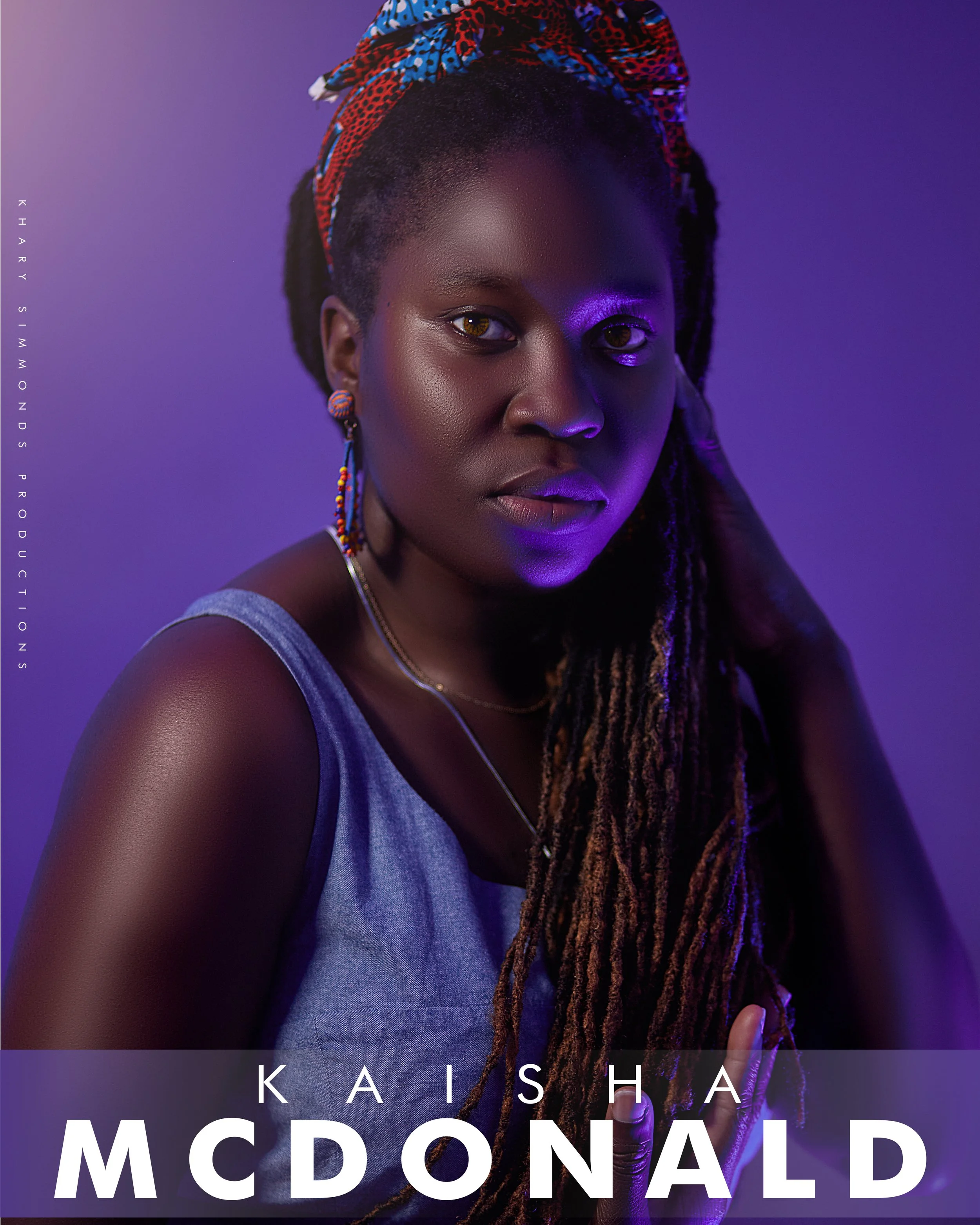 A woman with dark skin and dreadlocks wearing a colorful headscarf, earrings, and a gray top, illuminated with purple lighting. Her name, Kaisha McDonald, is displayed at the bottom of the image.