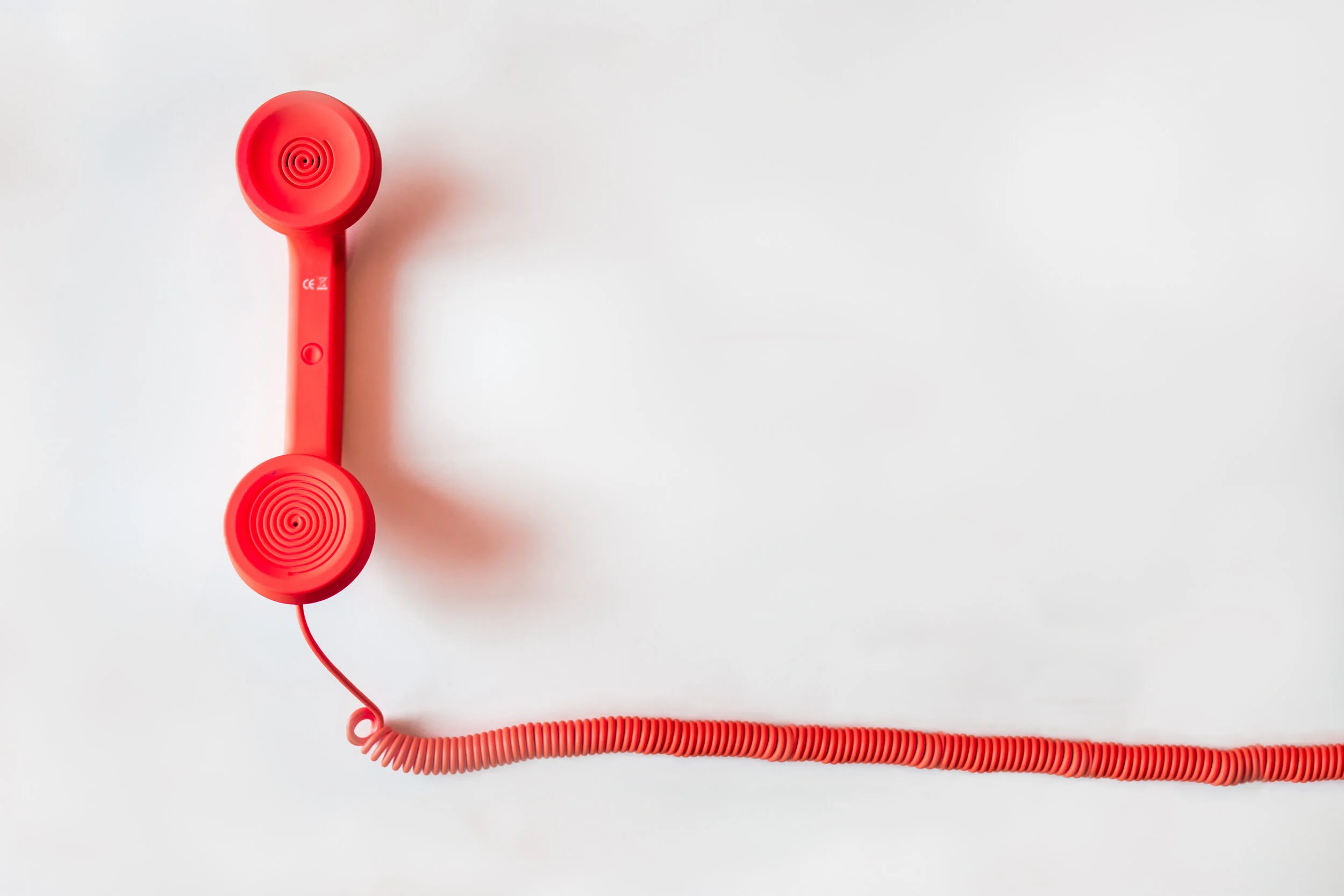 Canva - Red Corded Telephone on White Suraface.jpg