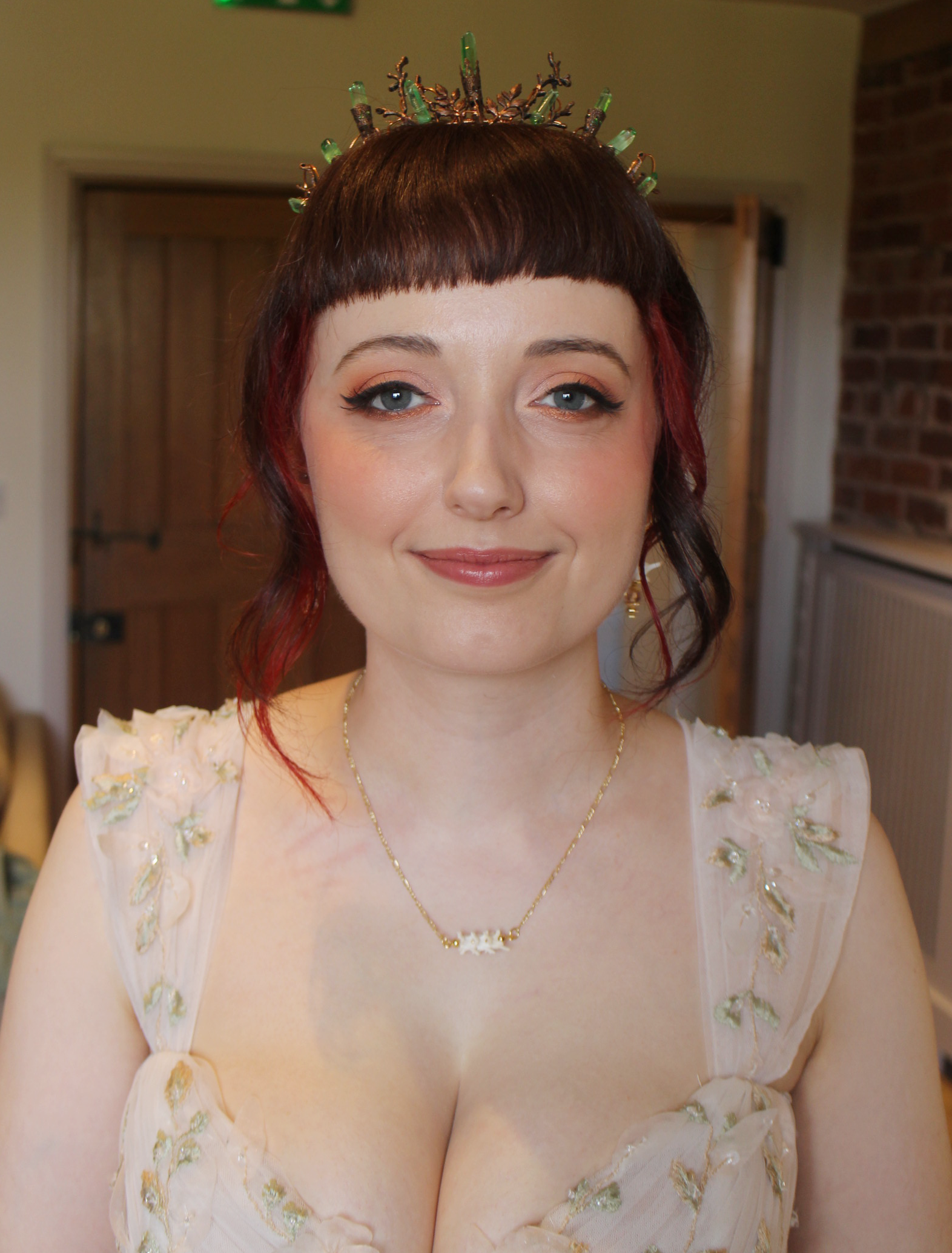 alternaitvr bride with green crown and winged eyeliner in floral dress worcetsershire wedding curradine barns .png