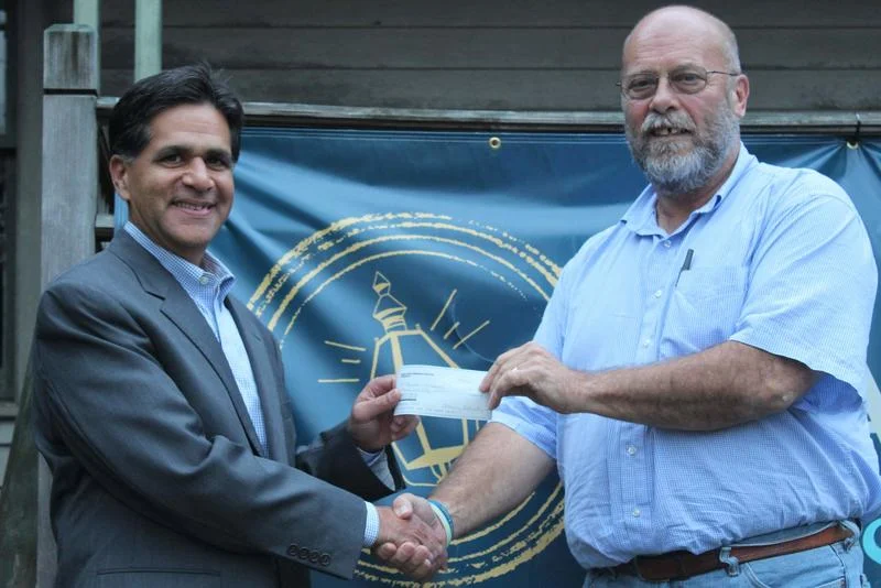 PHOTO: SHANNON HICKS Glenn Nanavaty, left, president and treasurer of Newtown Scholarship Association (NSA), acceptS a donation of $1,000 from Joe Hemingway, president of Sandy Hook Organization for Prosperity (SHOP), representing the funds for SHOP’s annual scholarship.