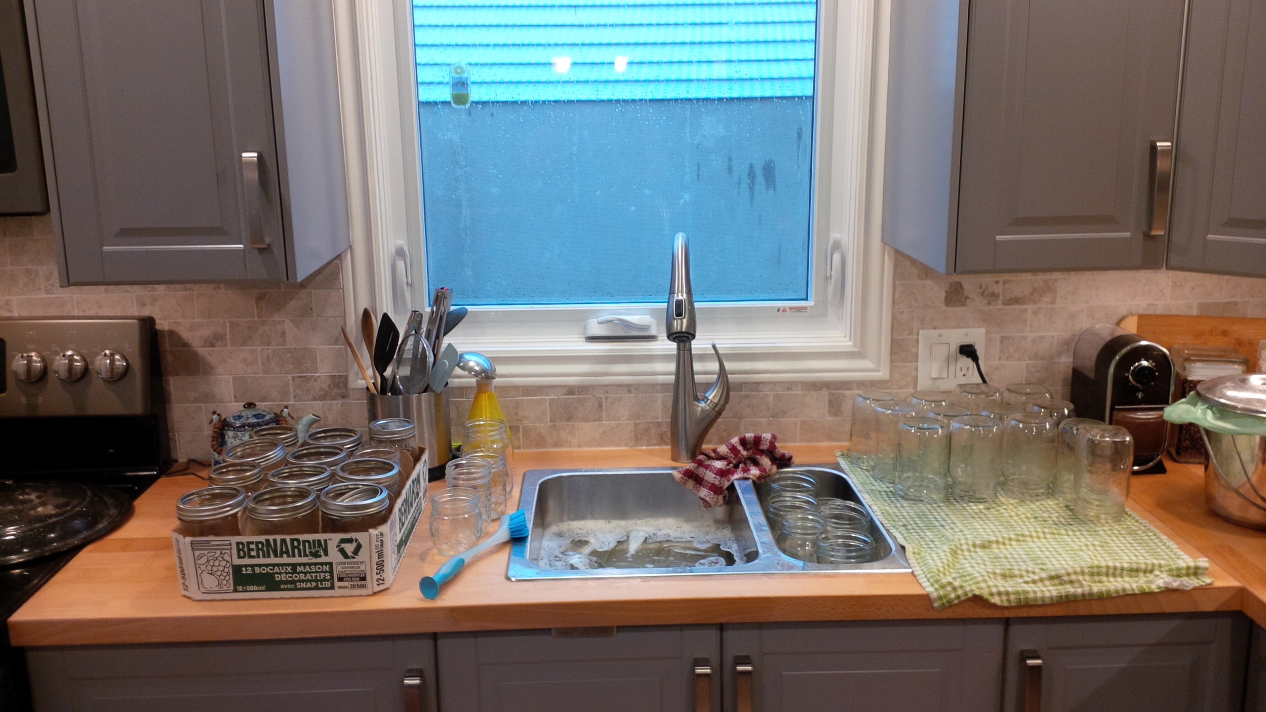 I brought all my empty Mason jars up from the pantry to take a head count and give them all a good bath. 