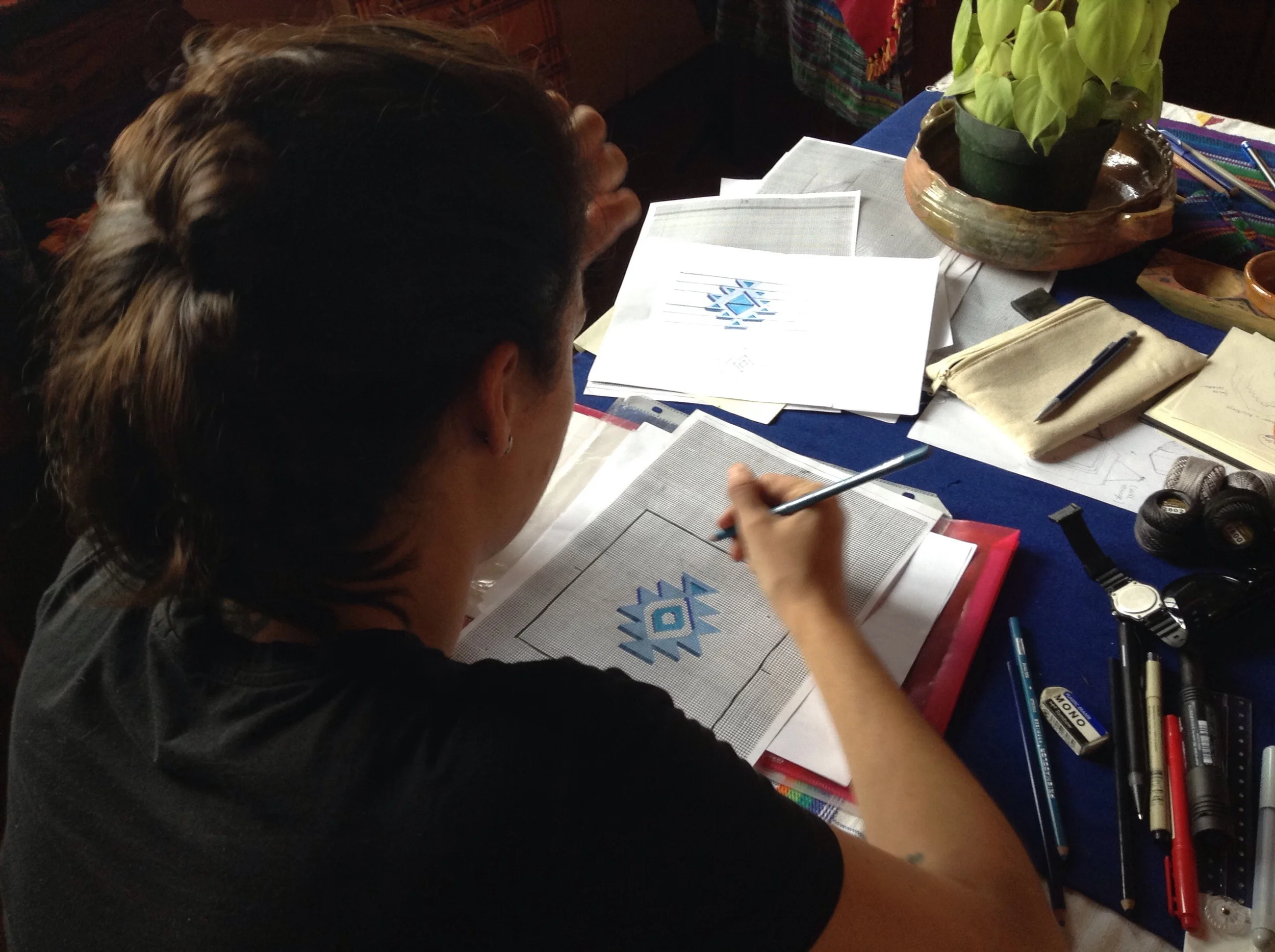 Designers sketched out their ideas on grid paper for original textile designs. Here, Aldana is mapping out her textile design.