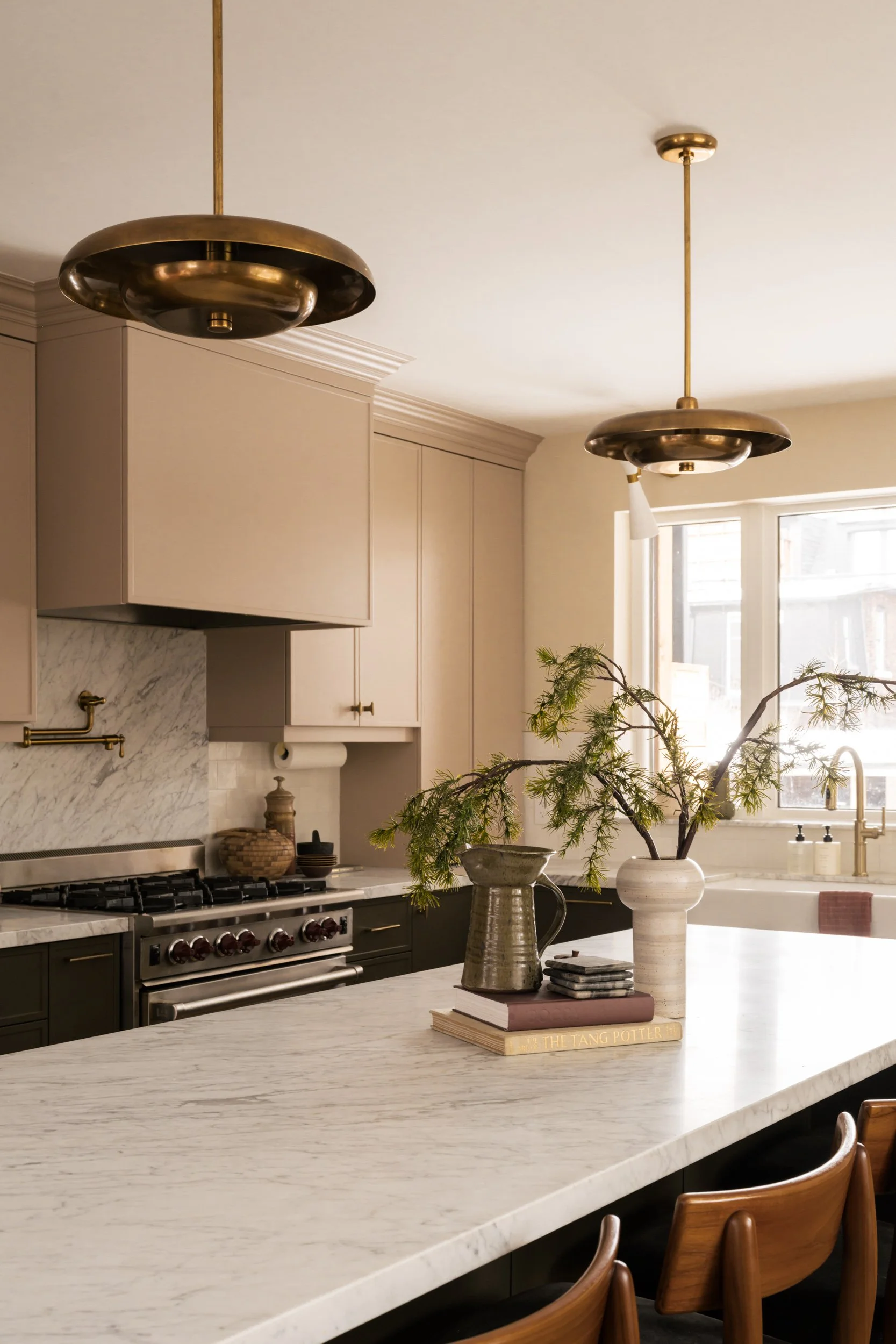 Vases and books styled on a kitchen island