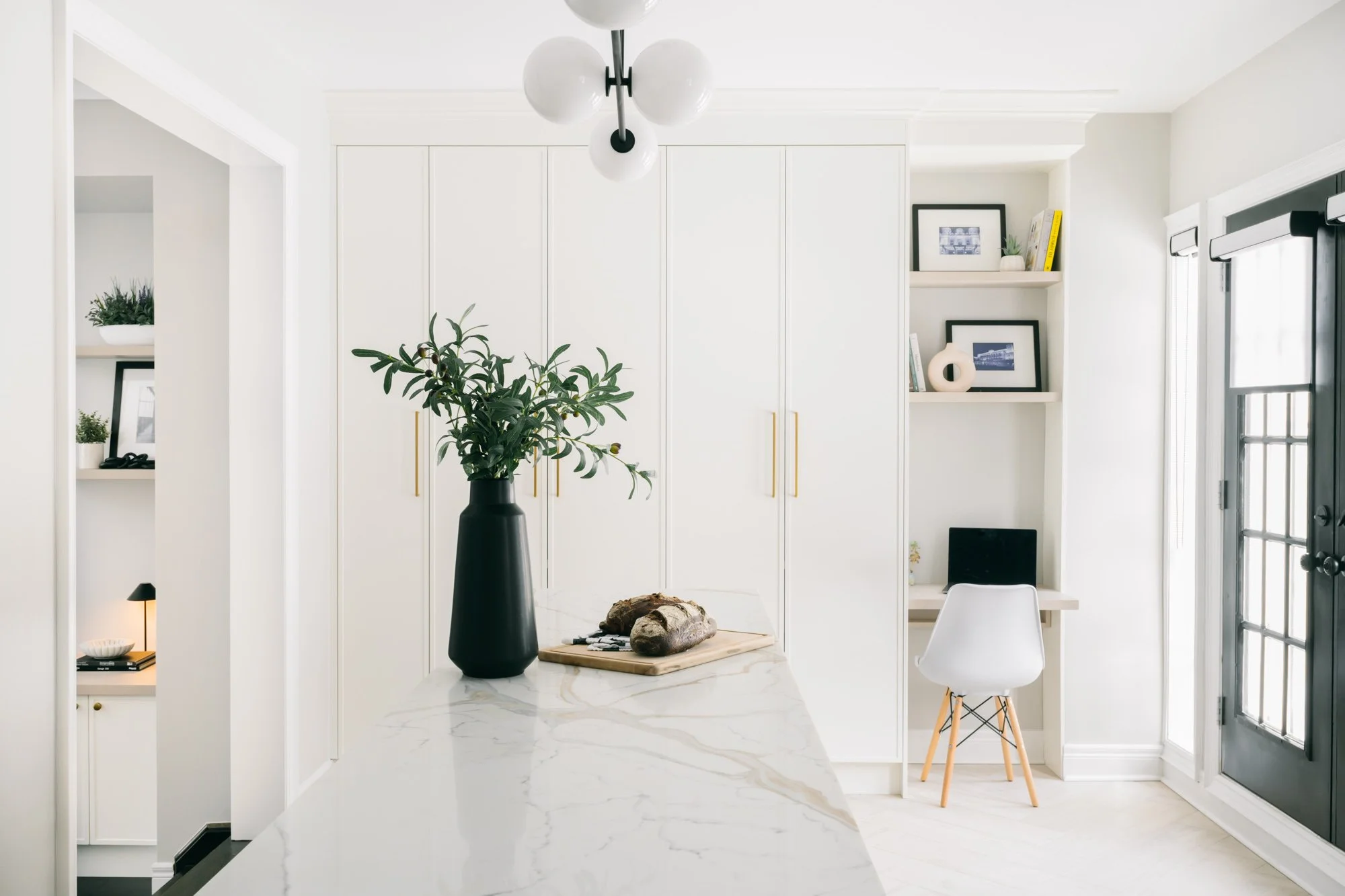 Built-in pantry with a small desk nook and built-in shelves above.