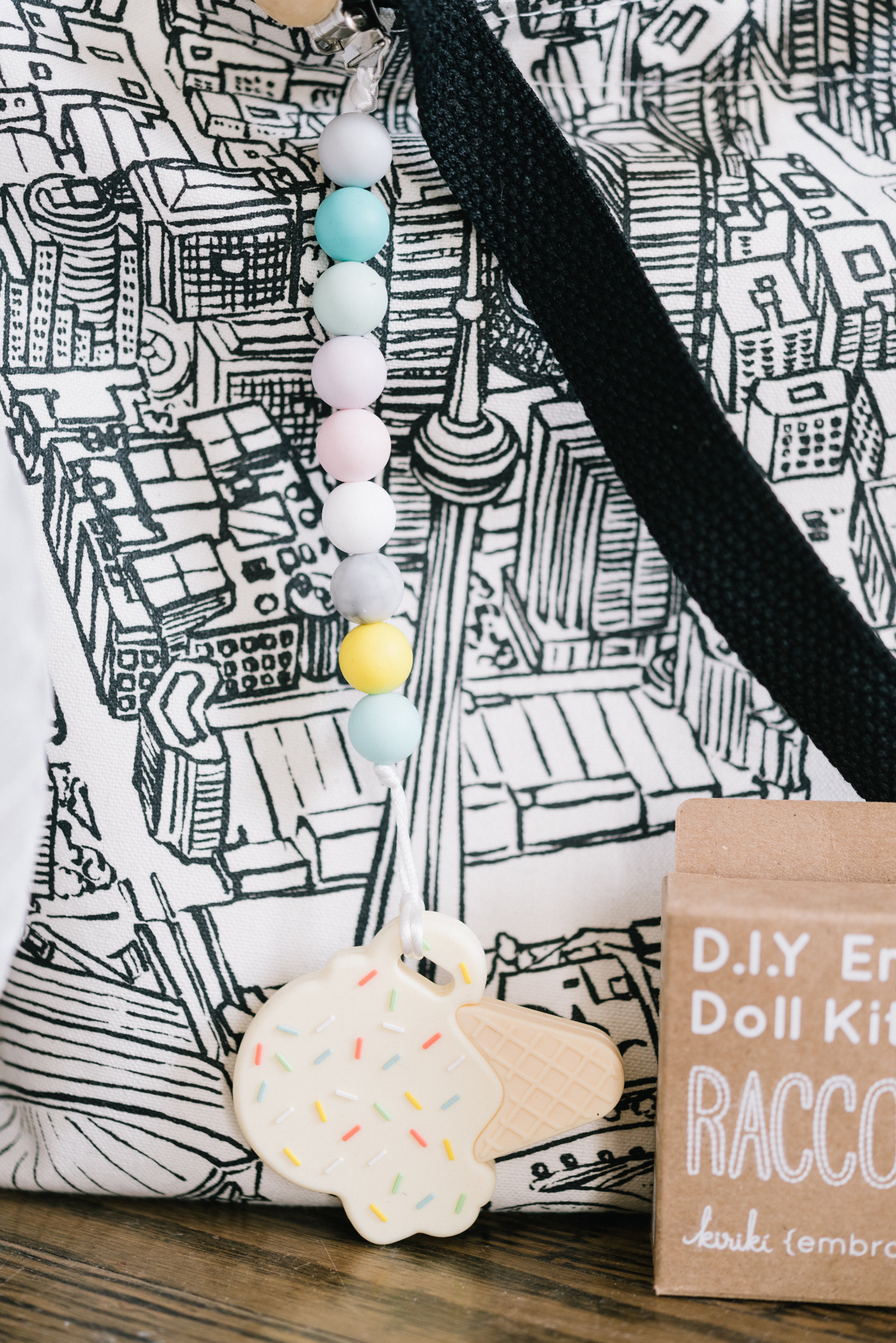 The cutest ice cream teether by Sweetie Pie Design Co ready to go on a Toronto skyline tote by Gotamago .