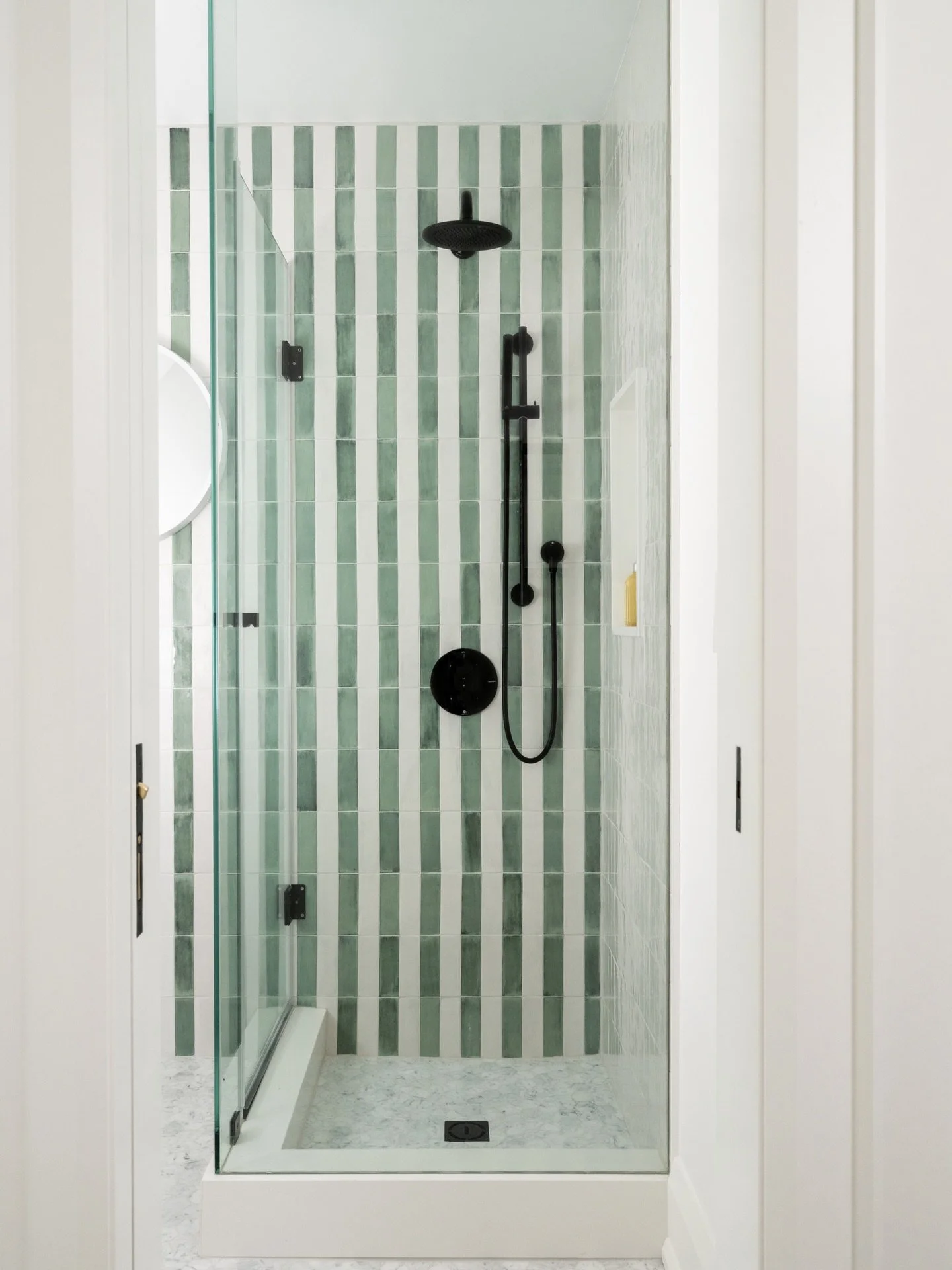 Here&rsquo;s one way to add fun and whimsy to your bathroom: a patterned tile wall with colour 💚🤍💚🤍

Build: @alairhomes.toronto
Glass: @doorsandmorefsa 
Photography: @janetkwan

#interiordesign #homerenovation #toronto #interiorphotography #bathr