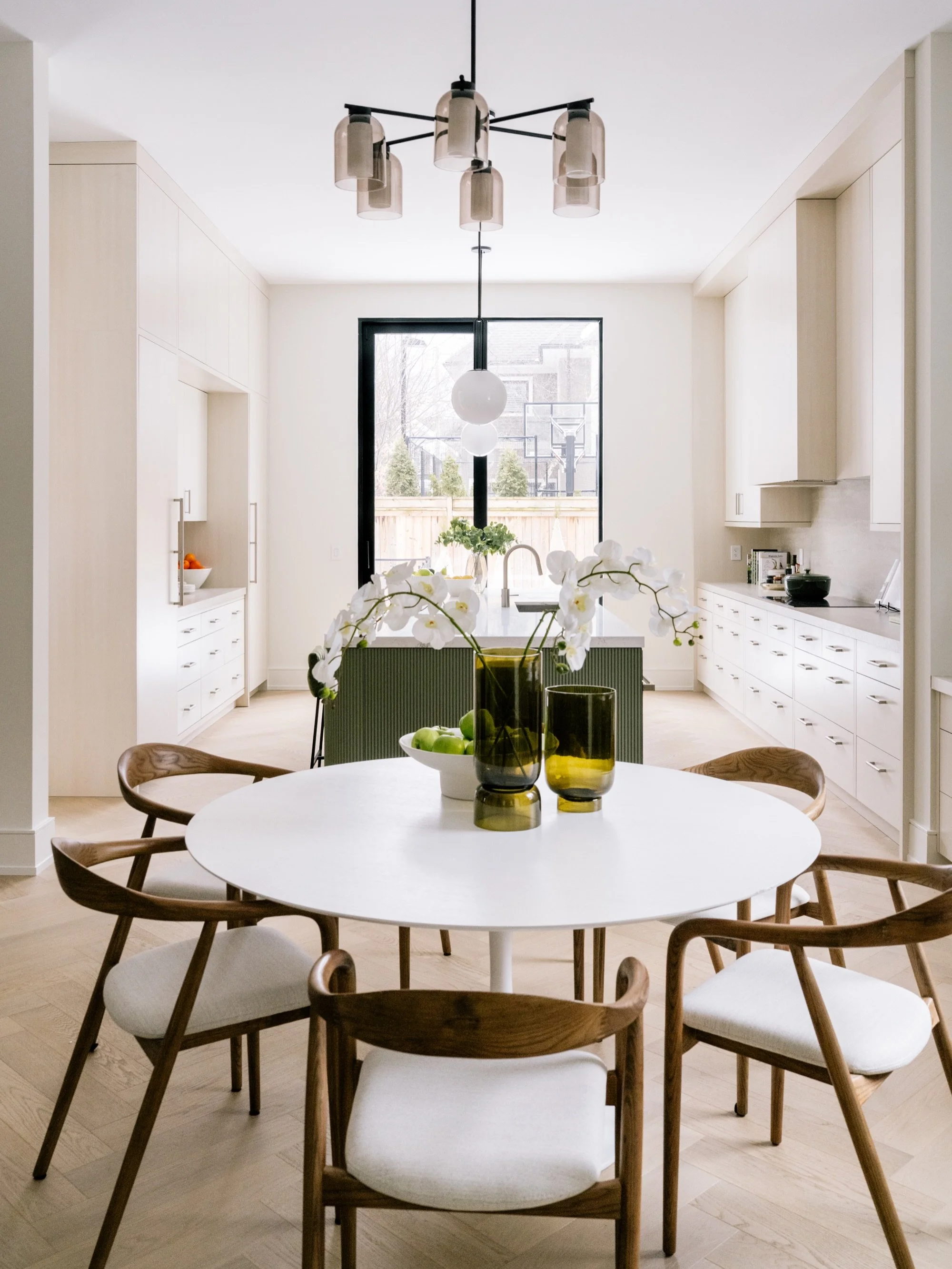 Off-white or cream coloured cabinets are a great alternative if you want add a bit of warmth to your kitchen without going with a full colour. And when you&rsquo;re ready to add more colour, the island is a good place to start. 

I love the green her