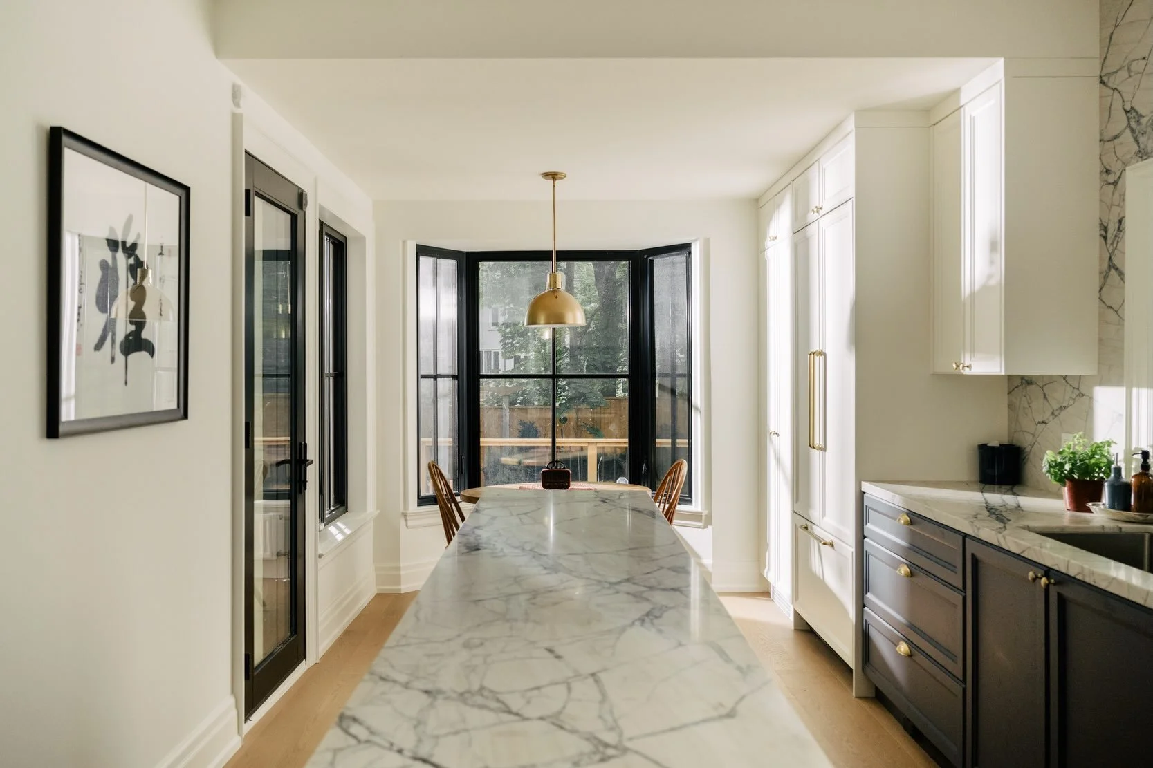 Breakfast by the bay (window). Take a tour of this deep blue and white kitchen with plenty of countertop space and cabinets for storage.

Also, did you notice the detail embedded in some of the cabinet doors? It gives them a nice touch and is another