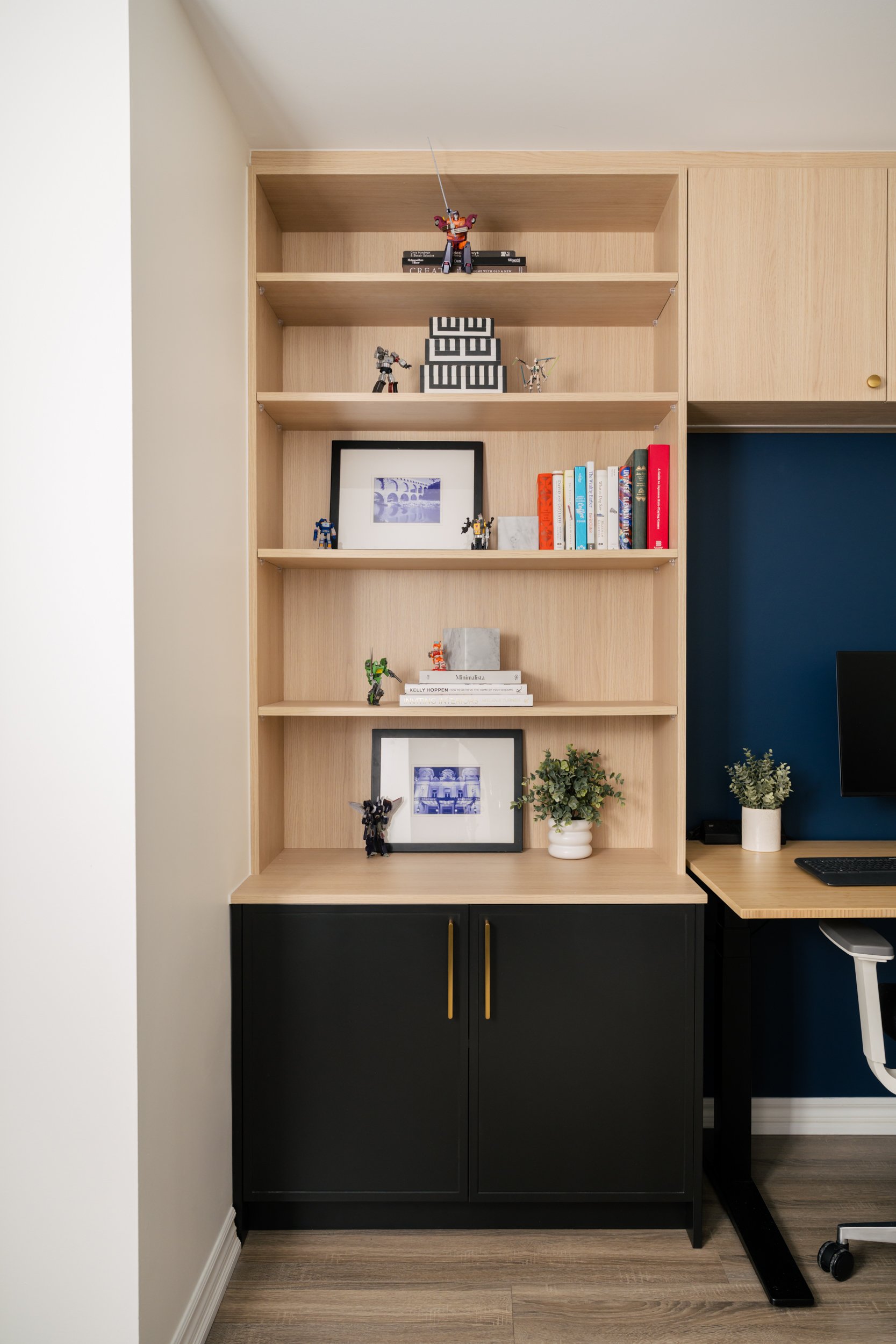 Home office with a built-in open shelving and closed lower cabinet
