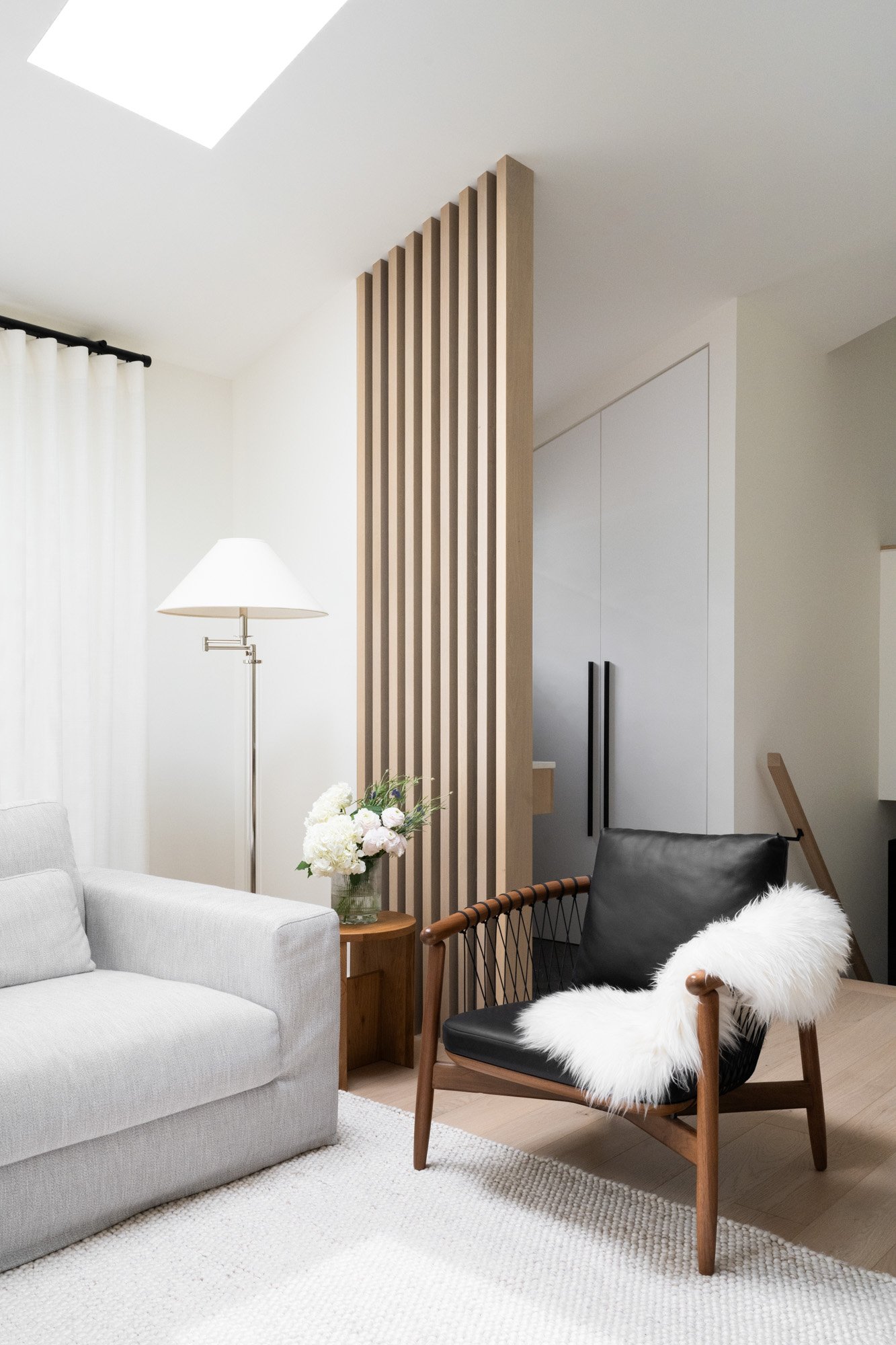 Slat wall room divider in the entryway beside the living room area.