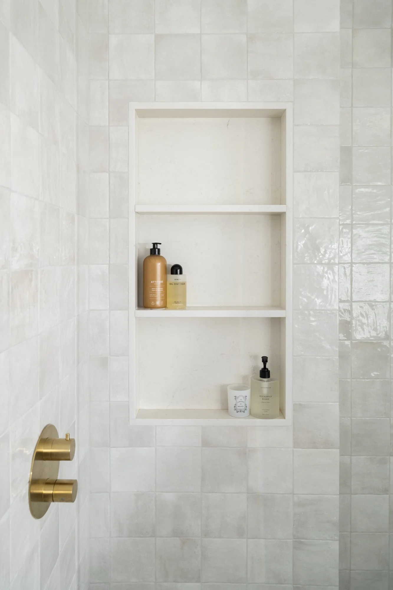 3-level shower niche in a shower with square tile