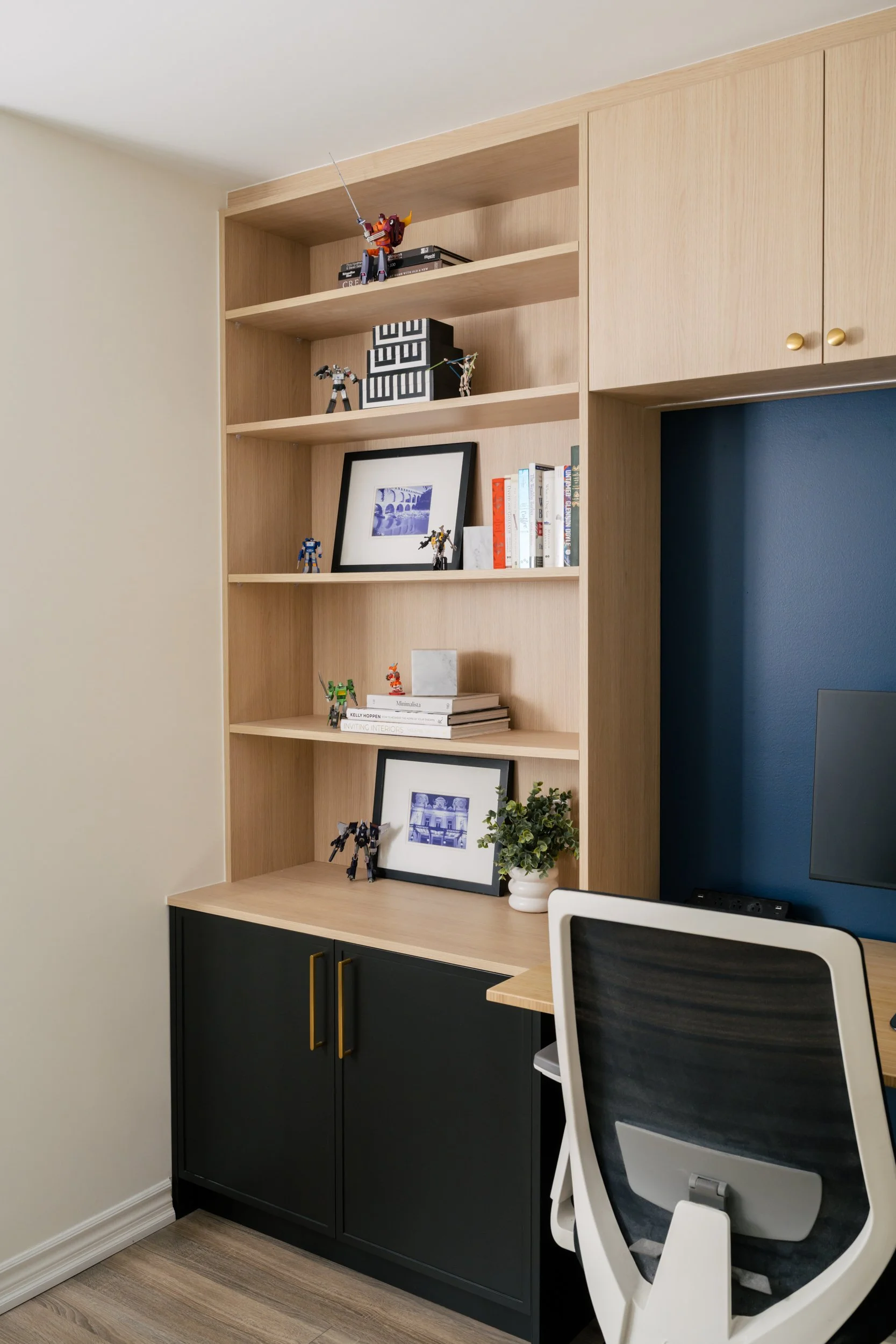 An angled view of a built-in open shelf and lower cabinet
