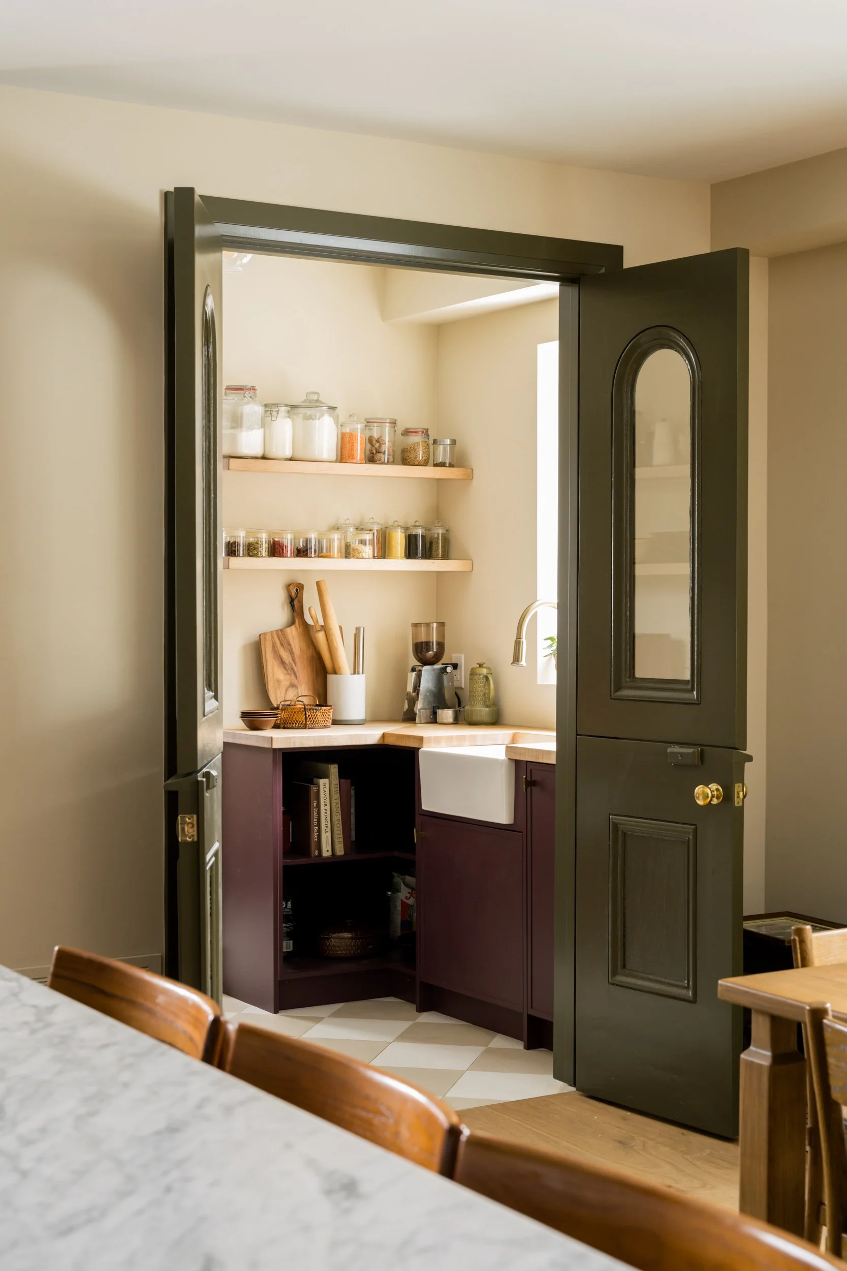 Sage green Dutch doors to a pantry fully open