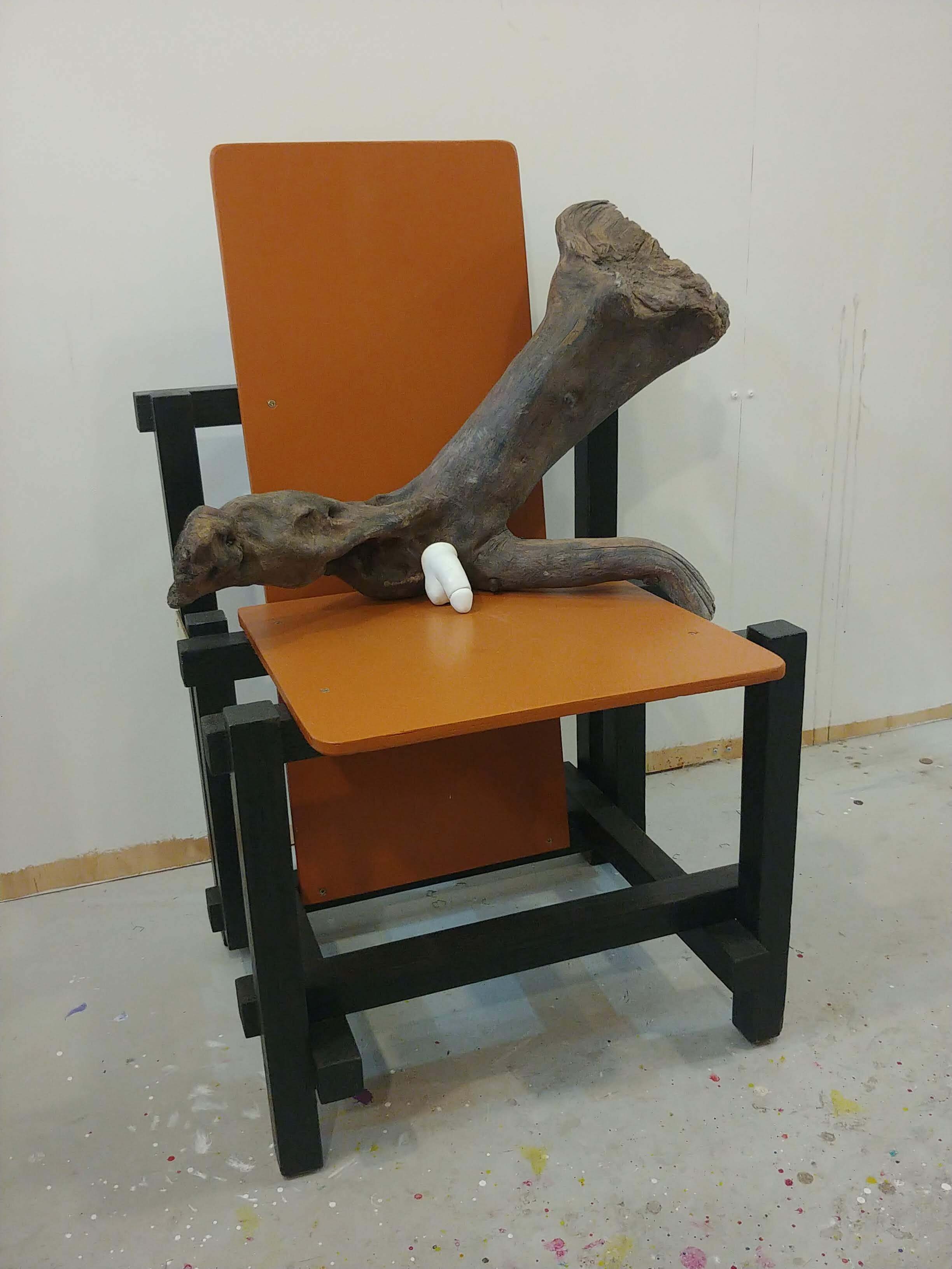 Half a Wooden Man on a Rietveld Chair