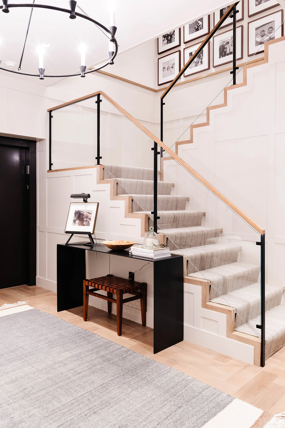 Staircase with gallery wall and chandelier