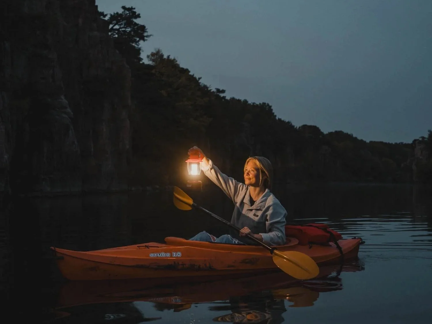 Kayaker with lantern at dusk for Travel South Dakota