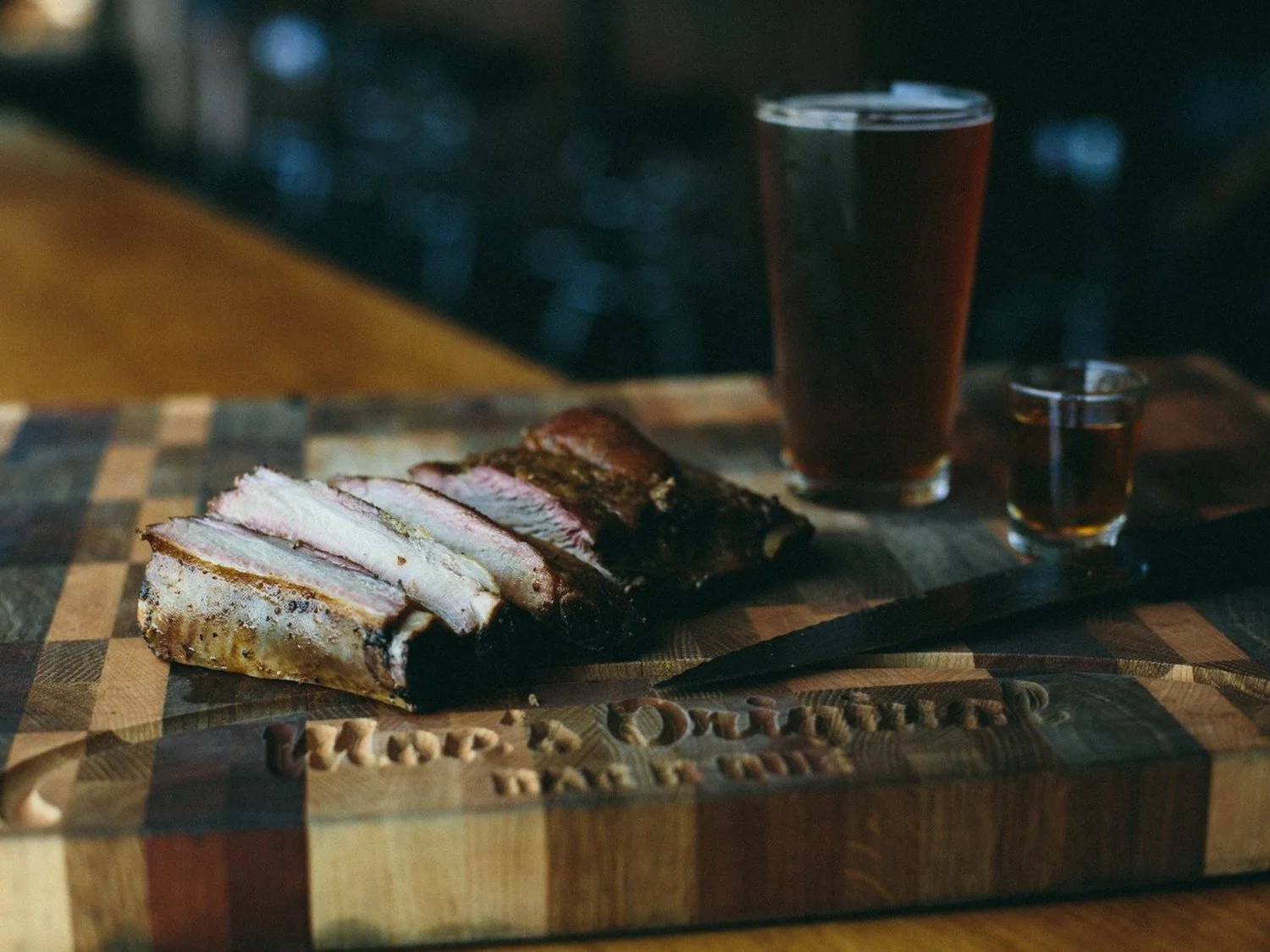Sliced brisket on a Moe's Original BBQ cutting board
