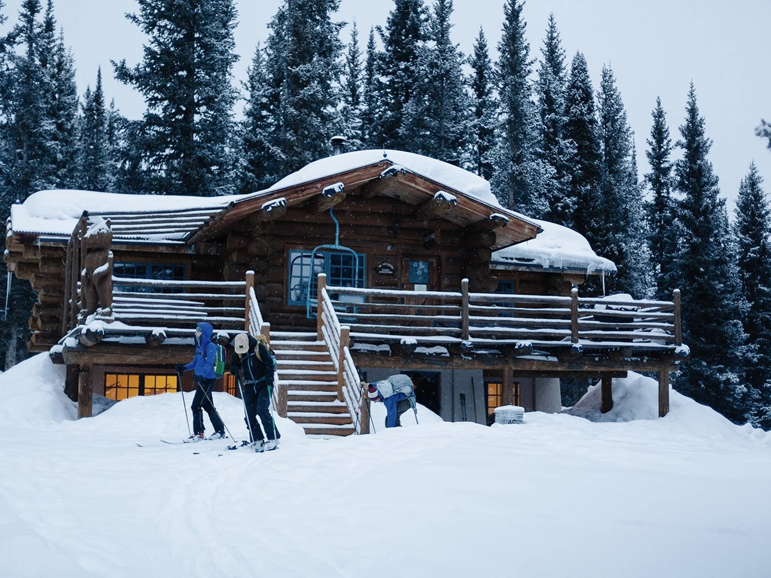Skiers arriving at a 10th Mountain Division hut in winter