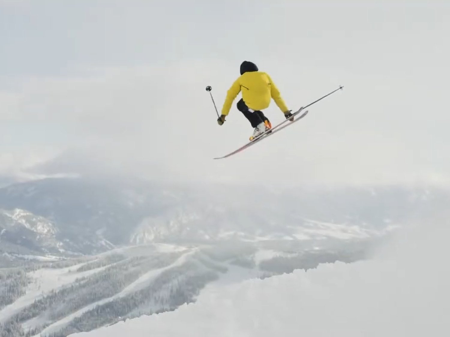 Skier airborne above Big Sky for the Mountain Collective