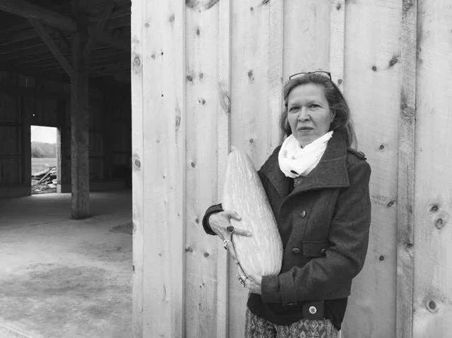 Punkin Shananaquet, a member of the Gun Lake tribe, holds a Gete Kosman squash at the Gteganes Farm in west Michigan. This squash, which until recently was thought to be extinct, is one of dozens of traditional crops being cultivated as part of a revival of foods native to the Great Lakes region. Courtesy of Jijak Foundation