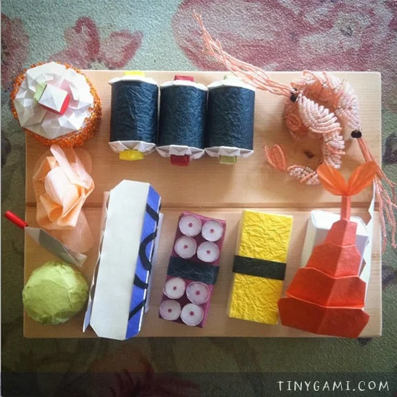 Folded paper origami and cut paper sculpted sushi
