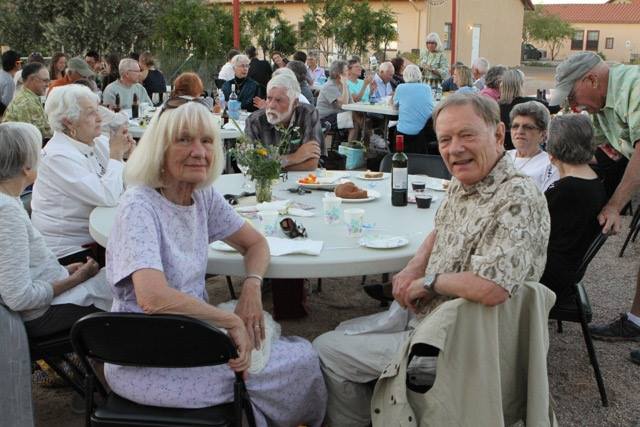Guests enjoying a farm-to-table meal in the courtyard at an event hosted by the Ajo Center for Sustainable Agriculture