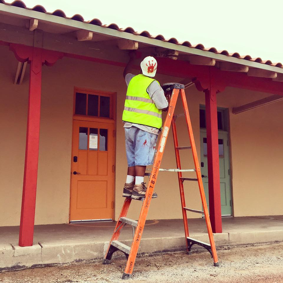 An apprentice putting the finishing touches on the South Wing during our opening season.