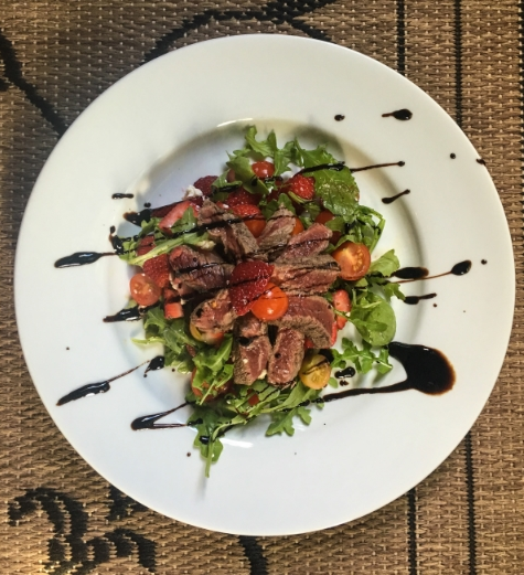 Strawberry Cherry Steak Salad plated and ready to eat.