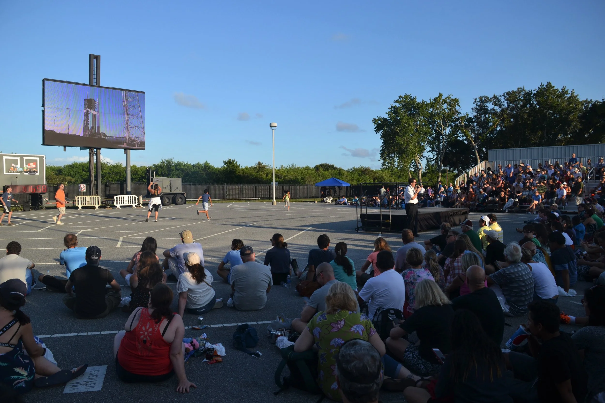 People gather at Kennedy Space Center to watch a rocket launch.