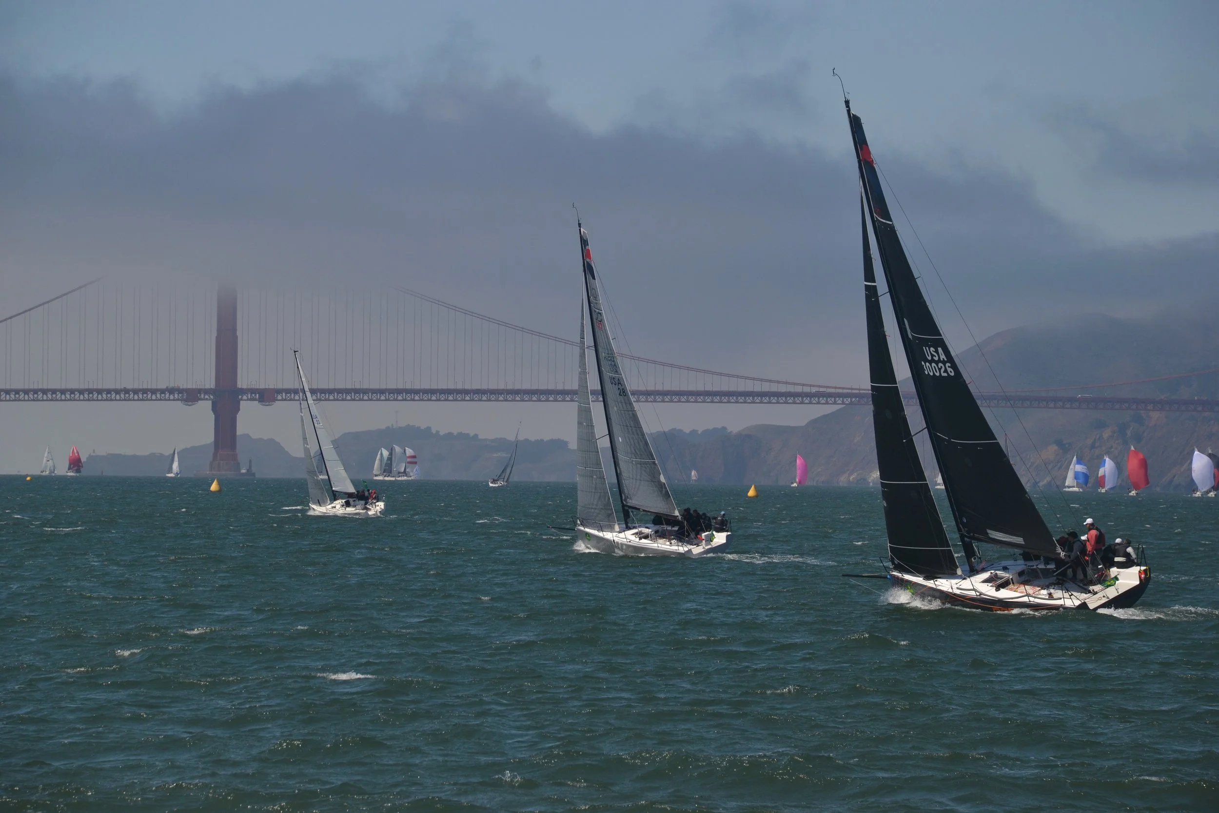 Boat racing beneath the Golden Gate bridge.